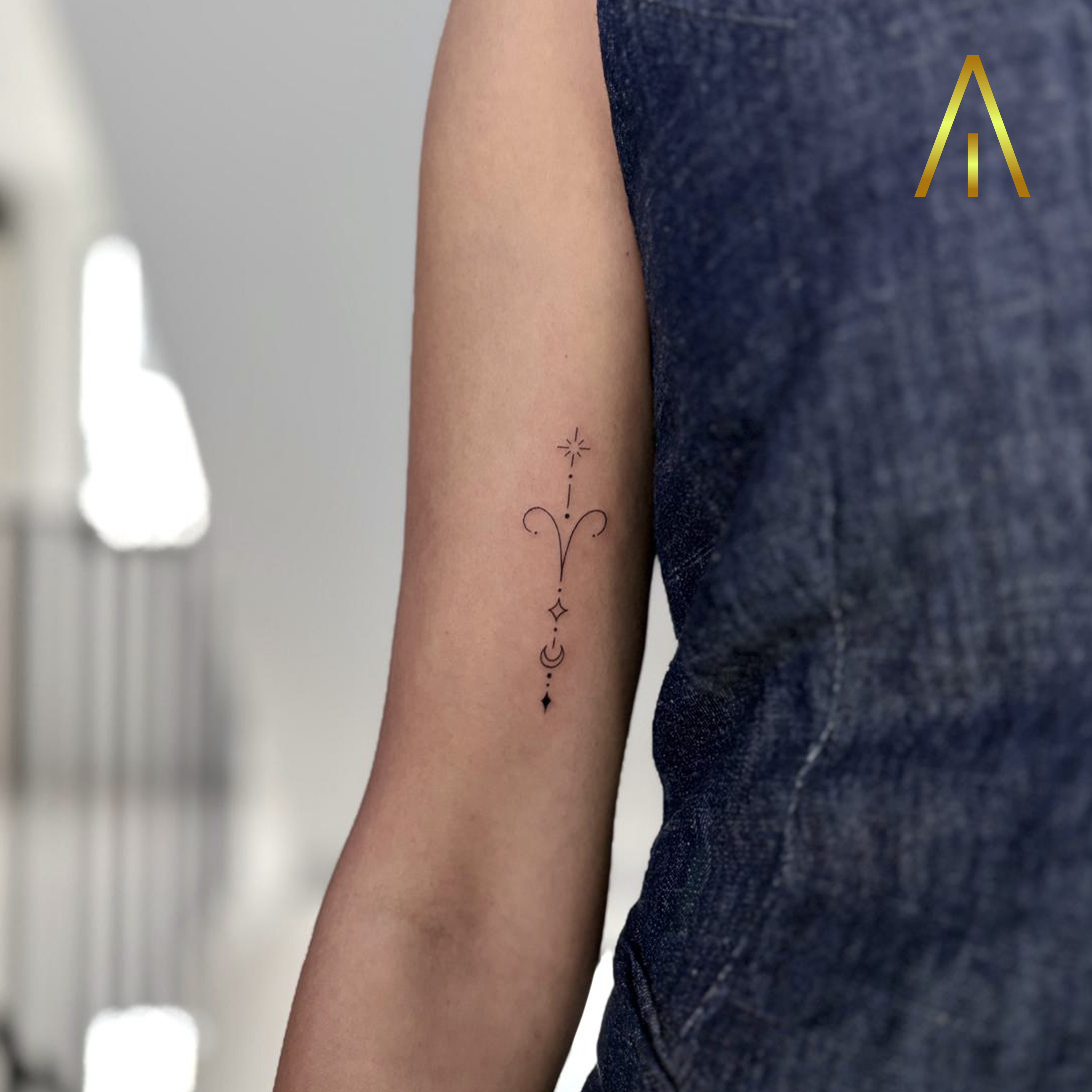 Fine line Aries zodiac ornamental upper arm tattoo Chiang Mai