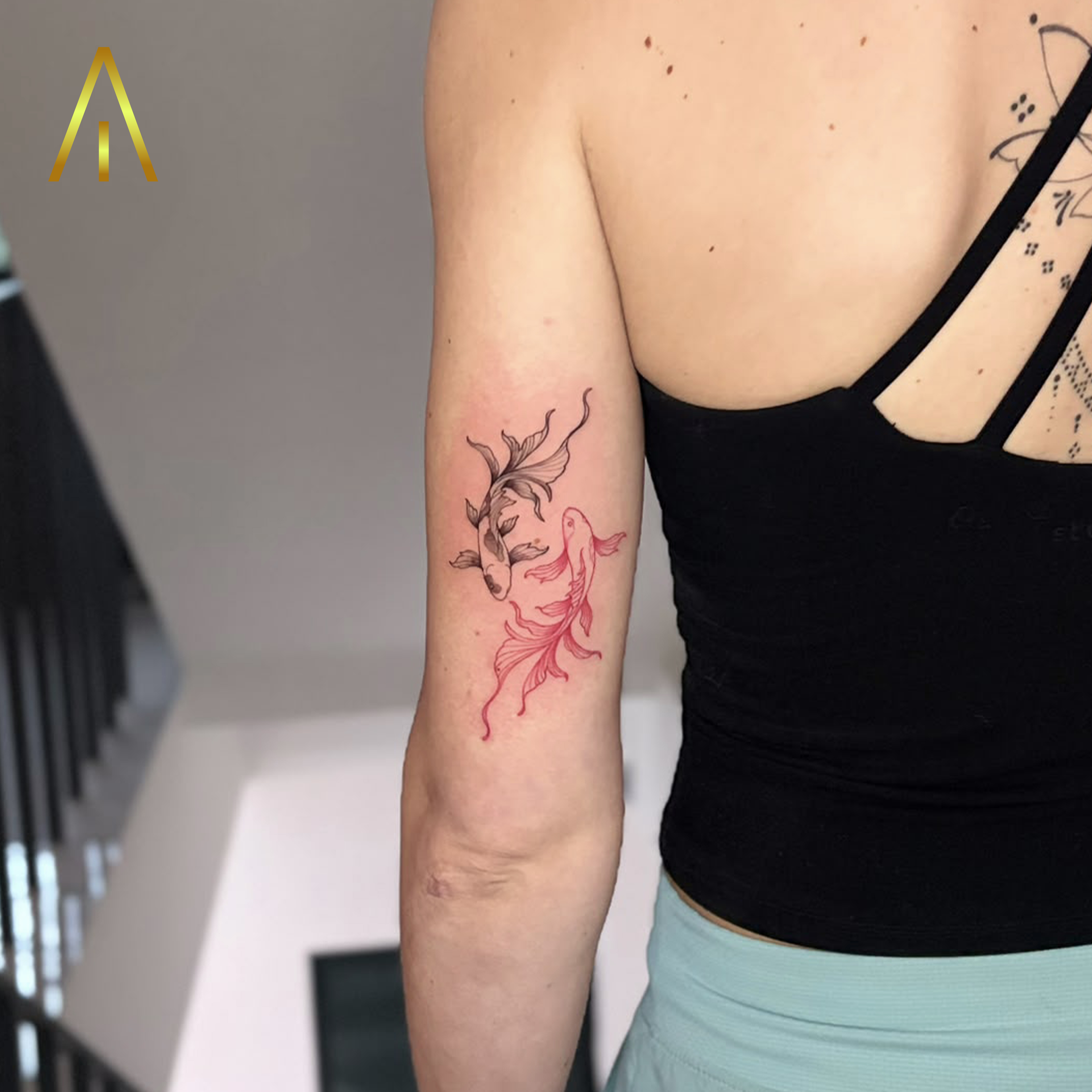 Taely minimal black and red koi fish yin yang upper arm tattoo Chiang Mai