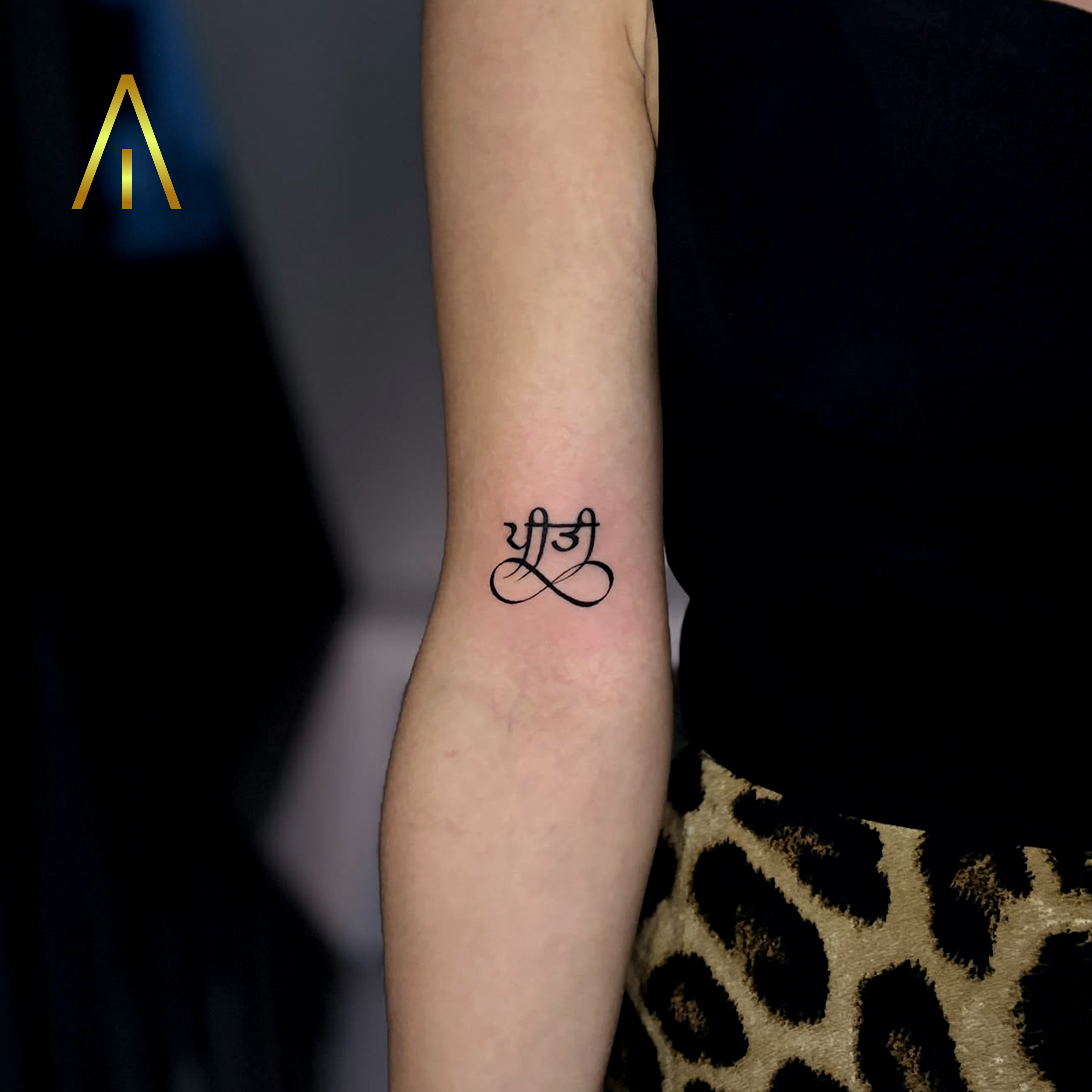 Mimi fine line Punjabi script infinity forearm tattoo Chiang Mai