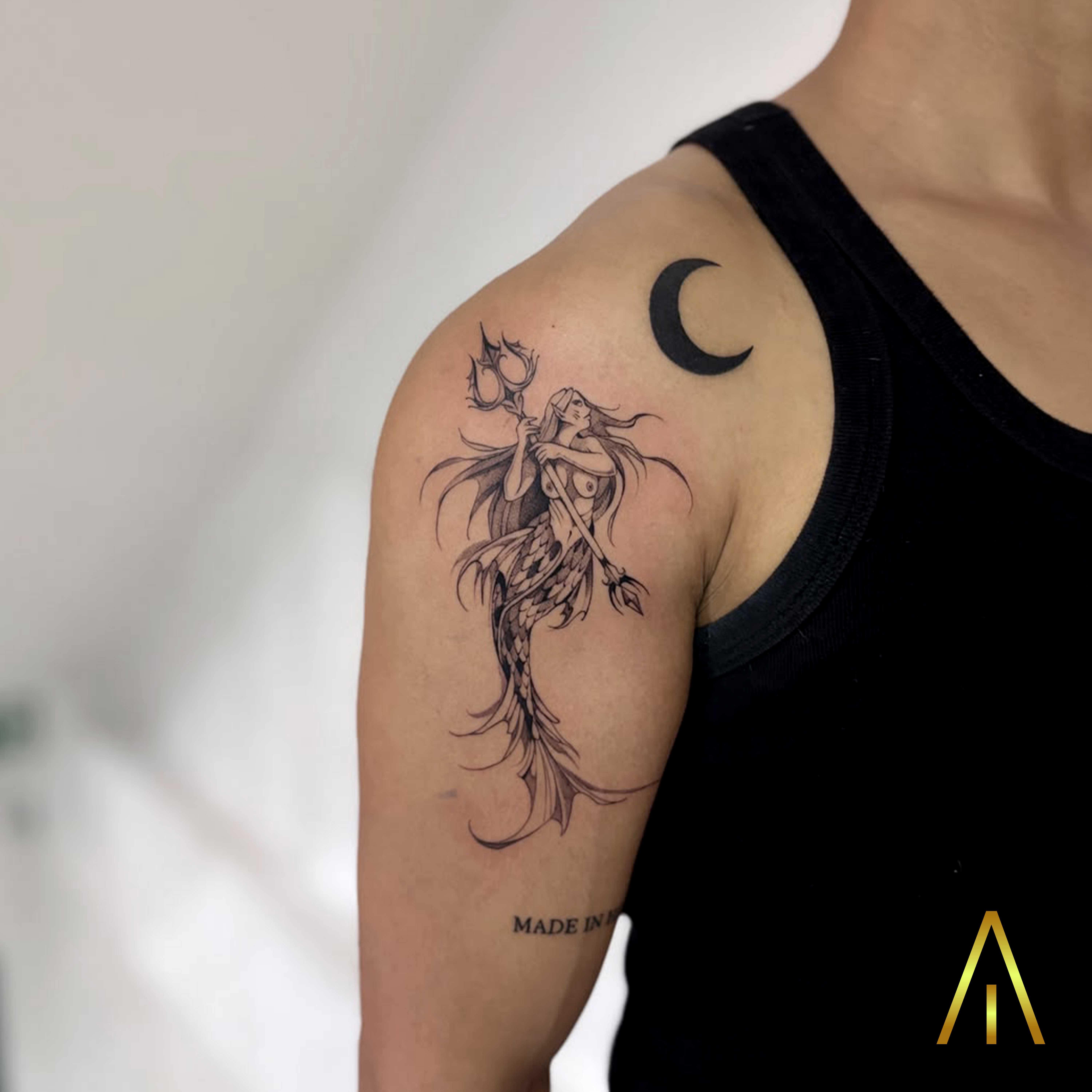 Katie mermaid with trident and crescent moon black and grey upper arm tattoo Chiang Mai