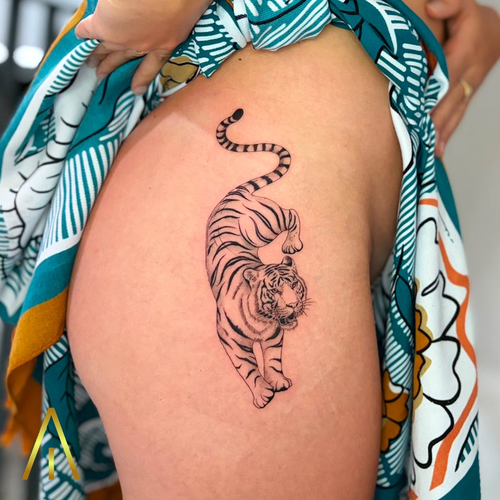 Fine line tiger crawling tattoo on thigh Chiang Mai