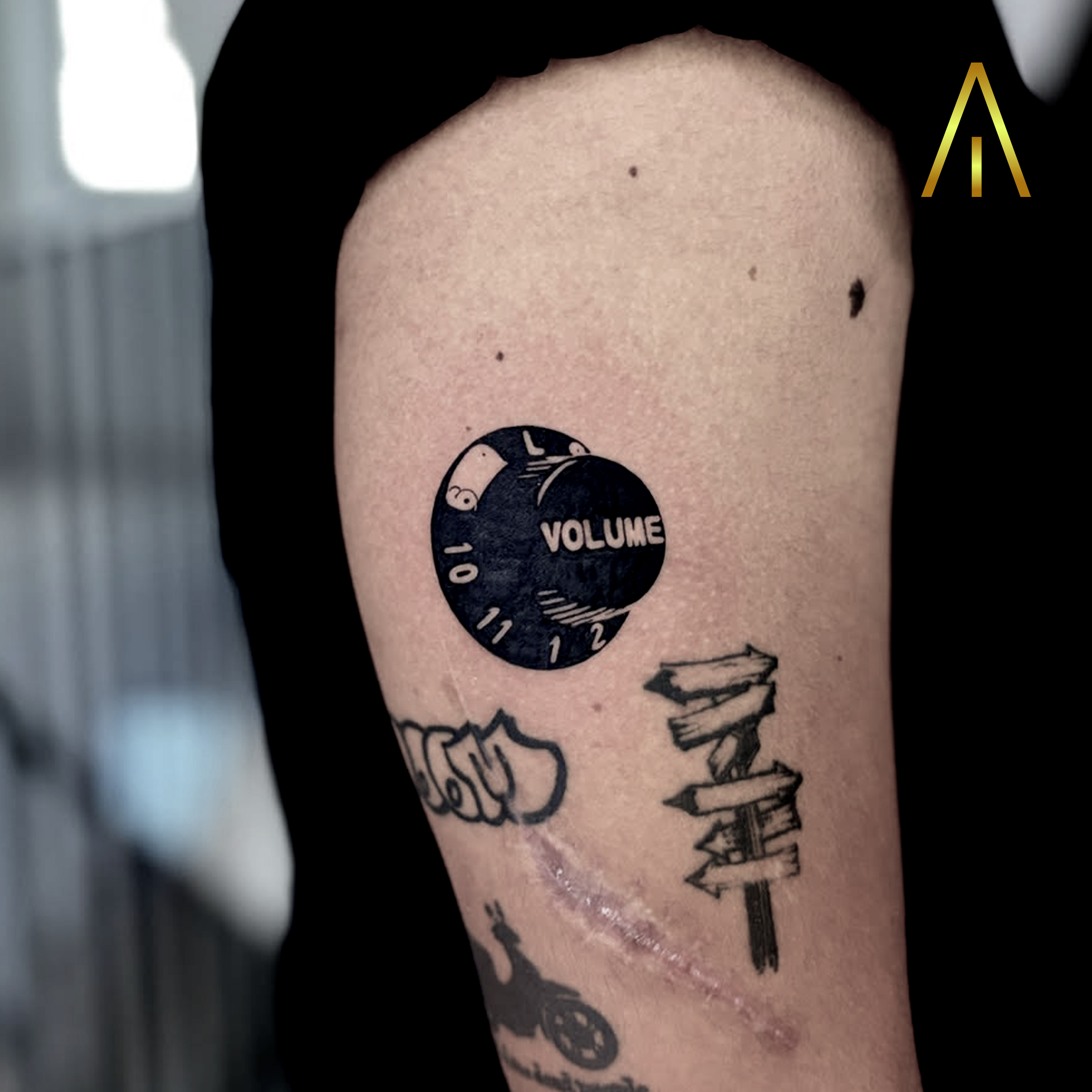 Miaa blackwork volume knob and signpost forearm tattoo Chiang Mai