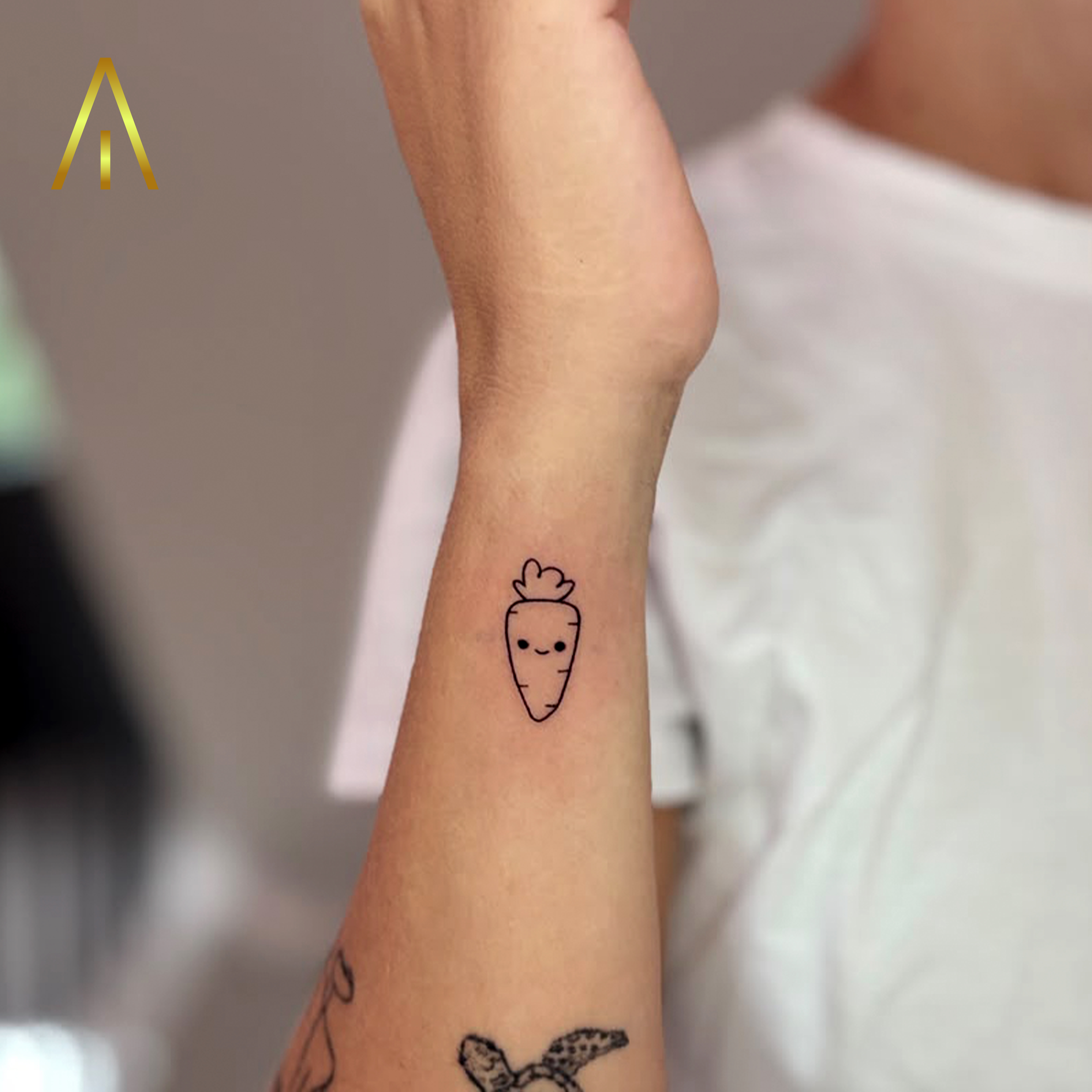 Fine line cartoon carrot forearm tattoo Chiang Mai