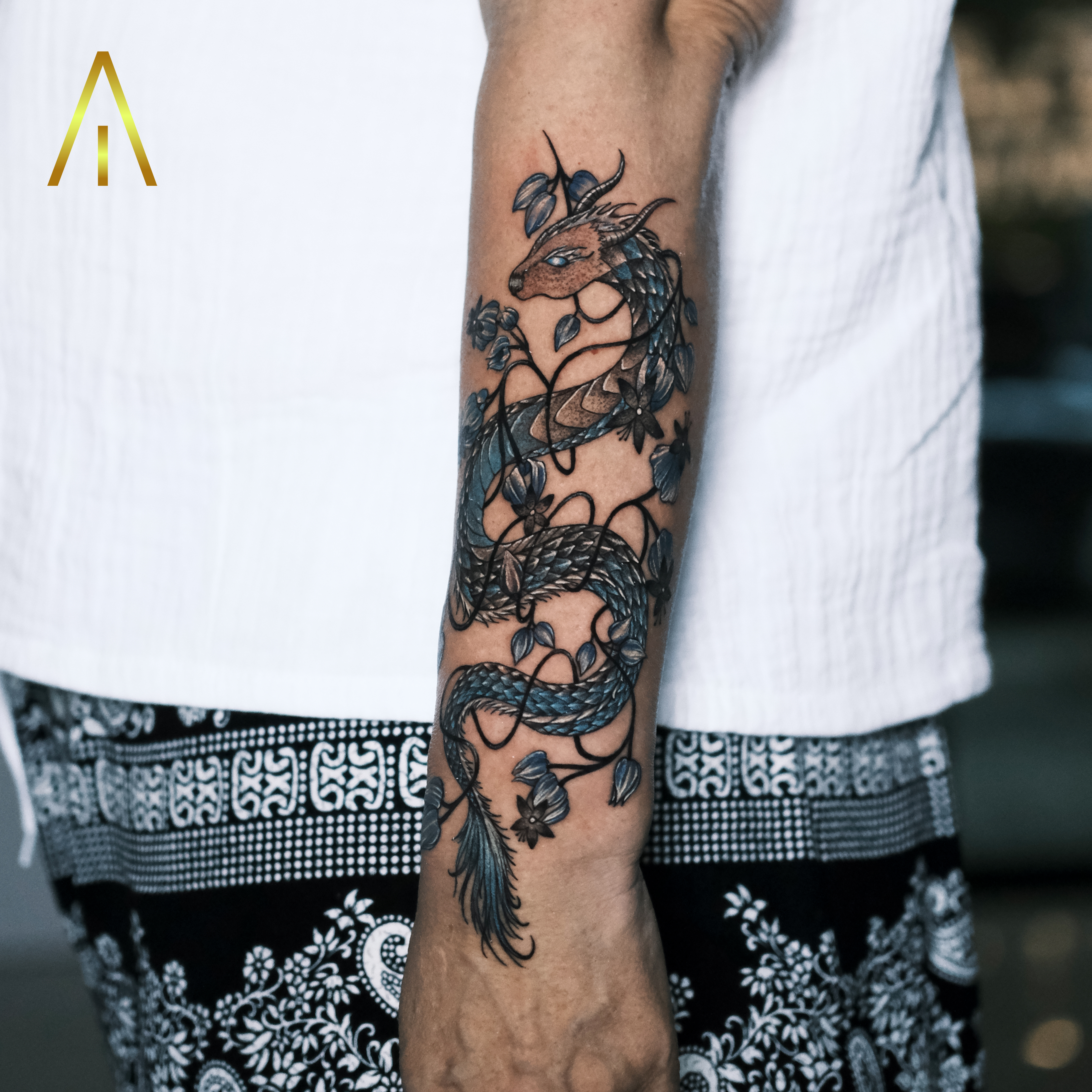 Taely colour blue dragon with floral vine forearm tattoo Chiang Mai