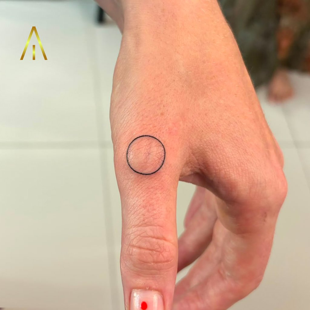 Minimalist fine line circle tattoo on the thumb, Artisan Ink Chiang Mai