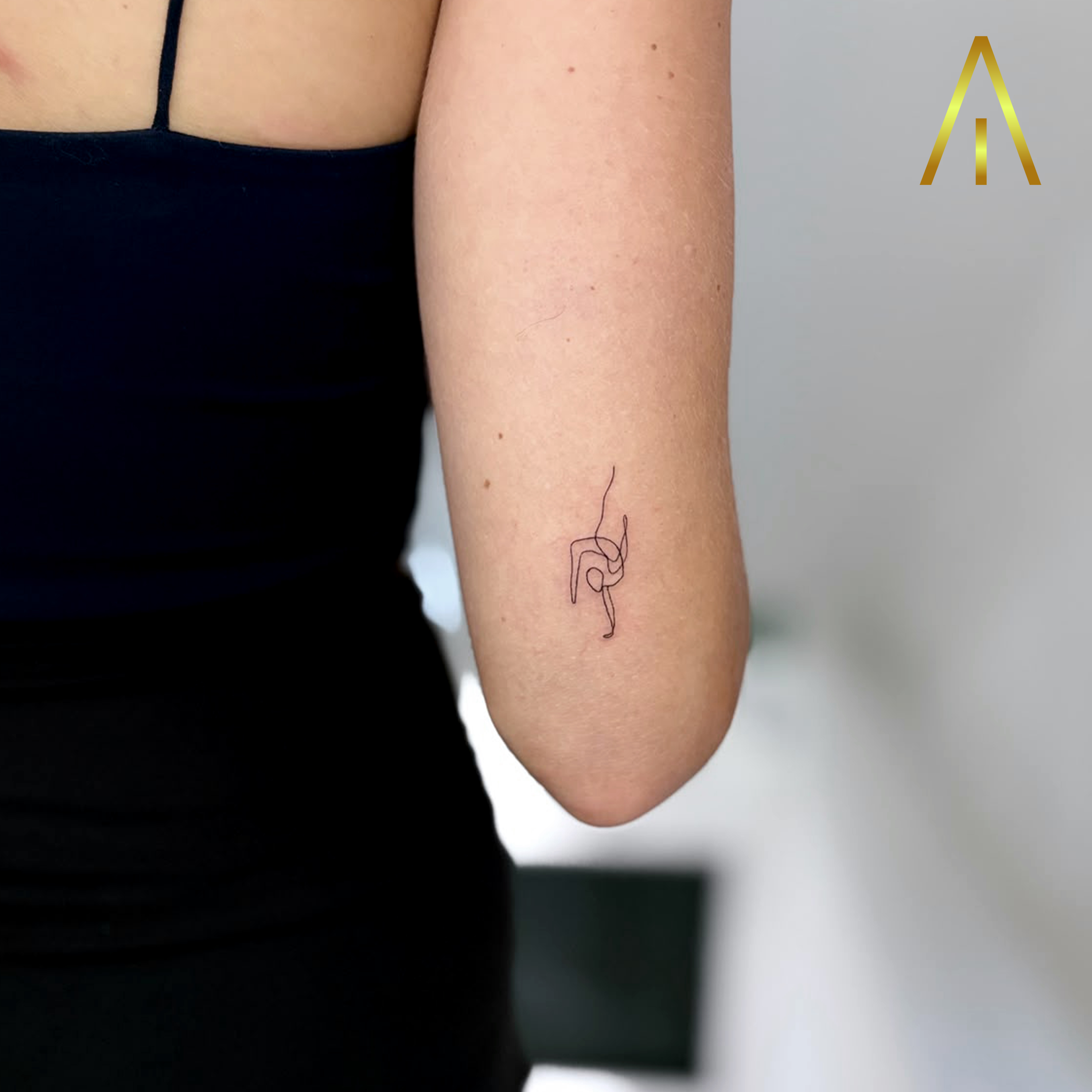 Mimi handstand yoga pose single line upper arm tattoo Chiang Mai