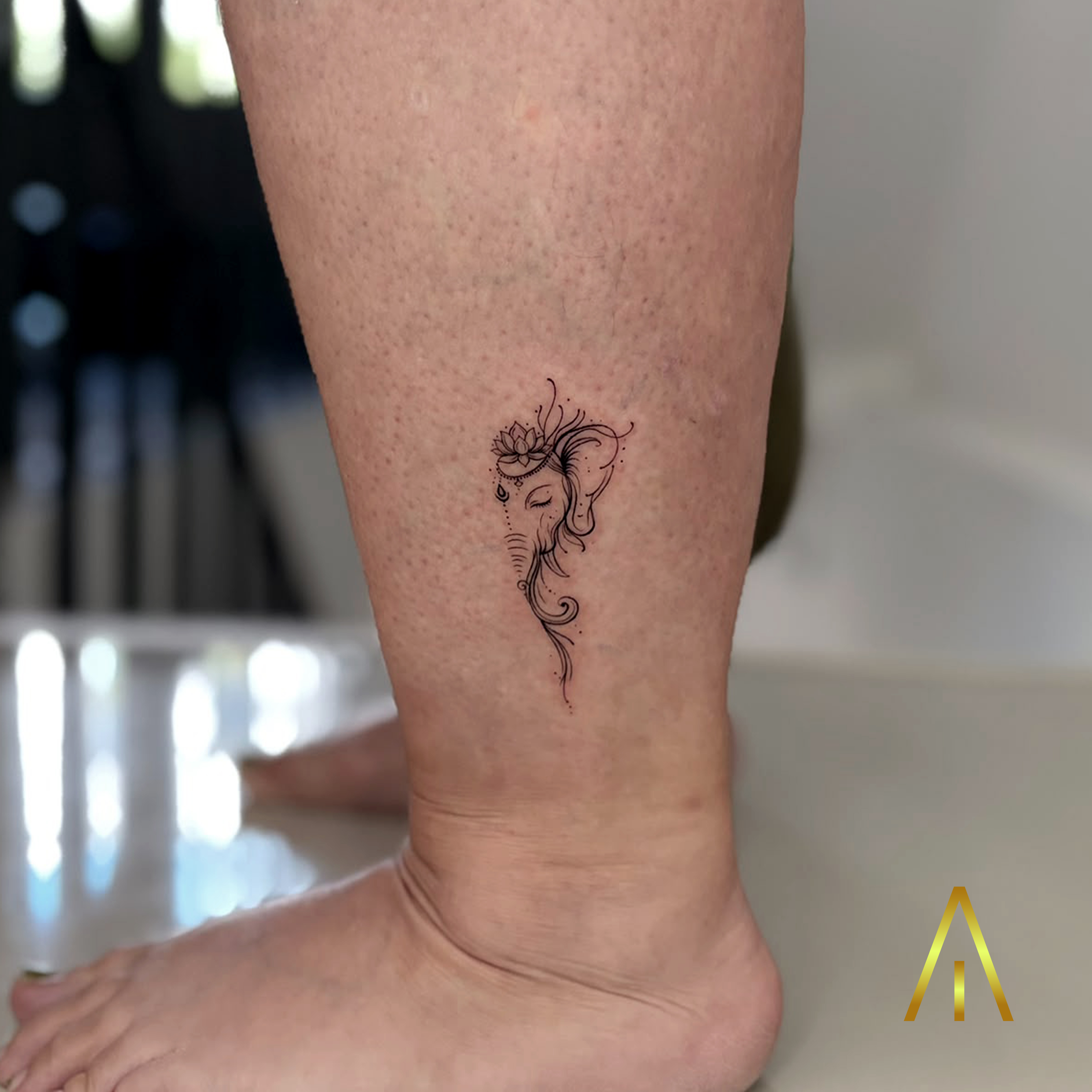 Katie fine line Ganesha with lotus calf tattoo Chiang Mai