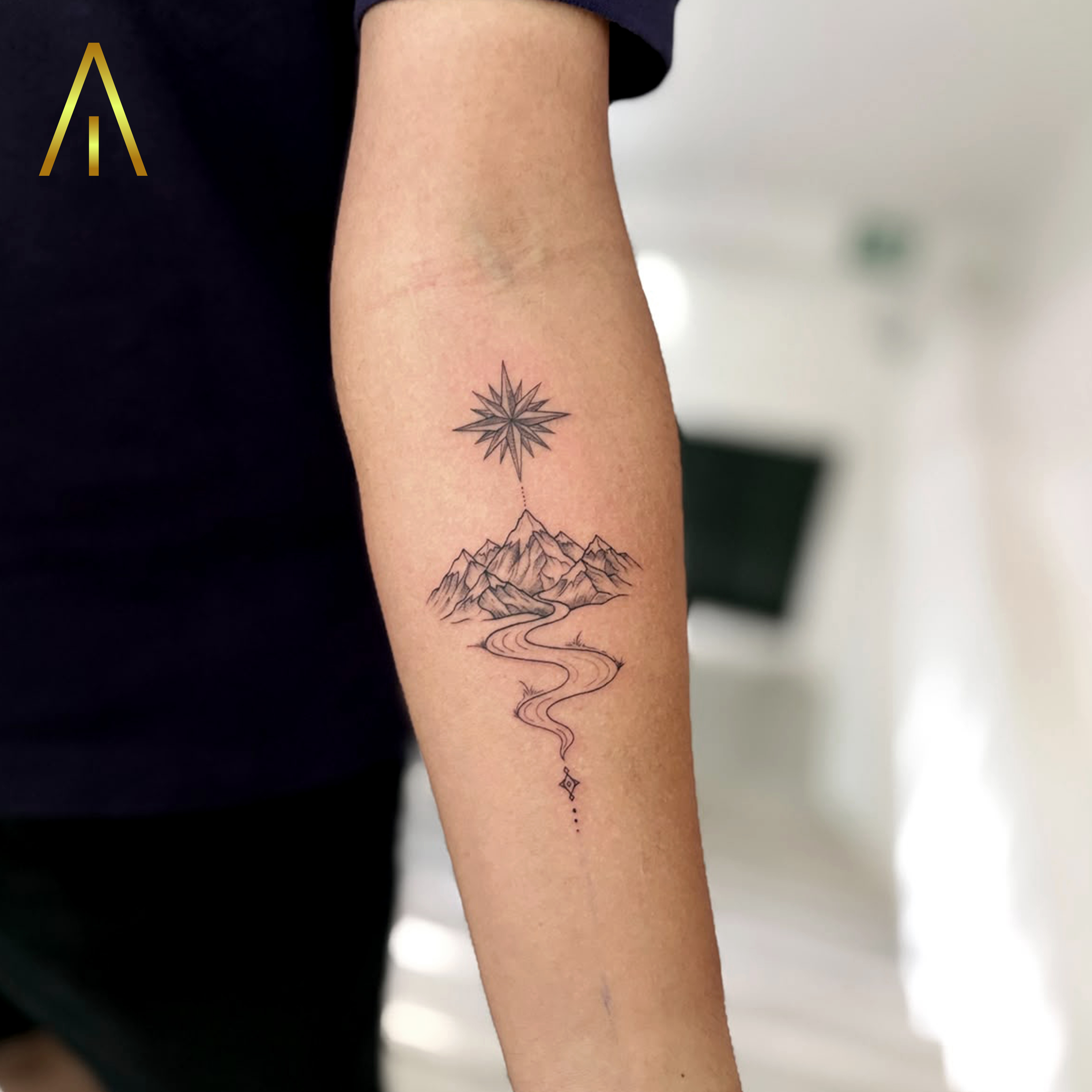 Mimi mountain range with starburst and path fine line forearm tattoo Chiang Mai