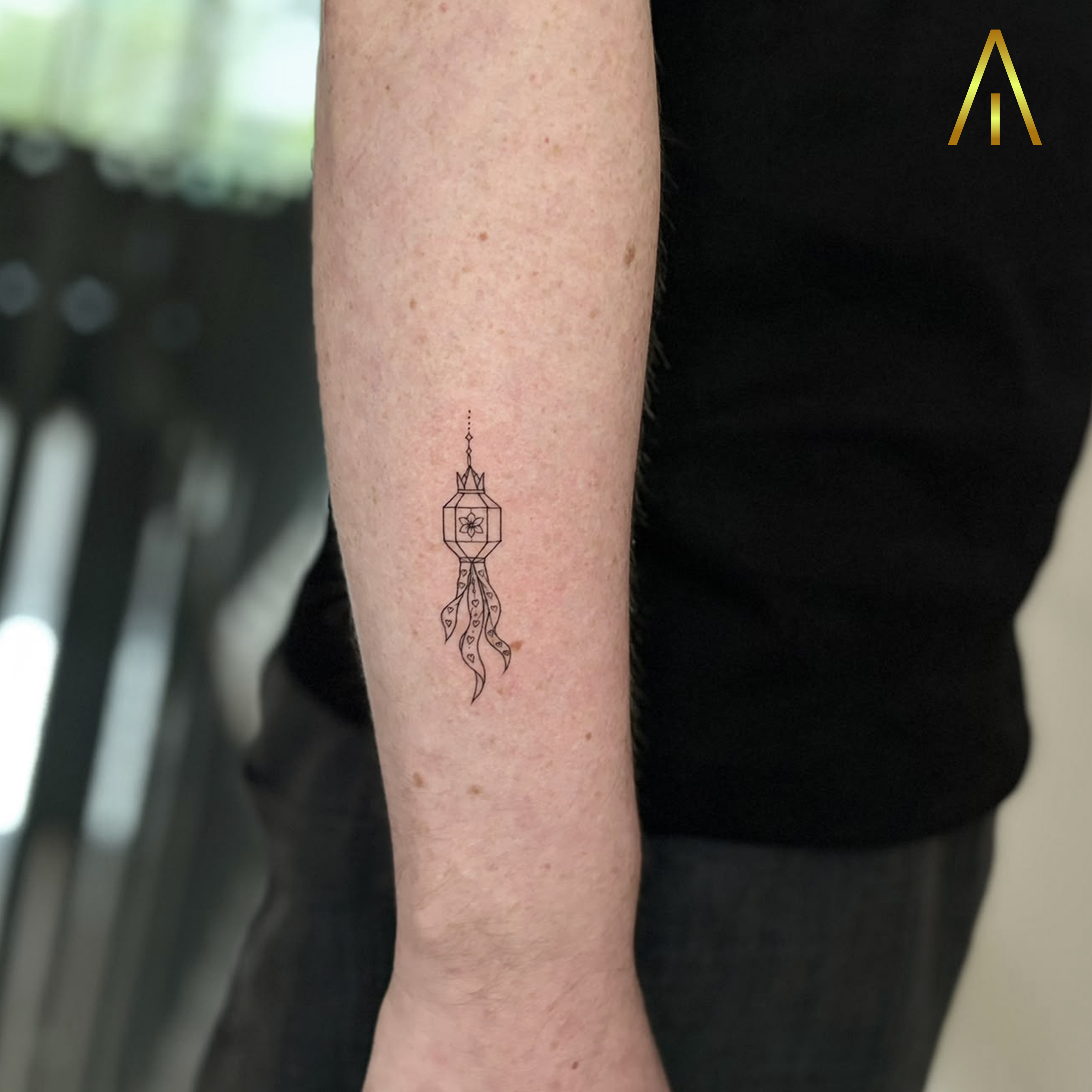 Mimi fine line hanging lantern forearm tattoo Chiang Mai