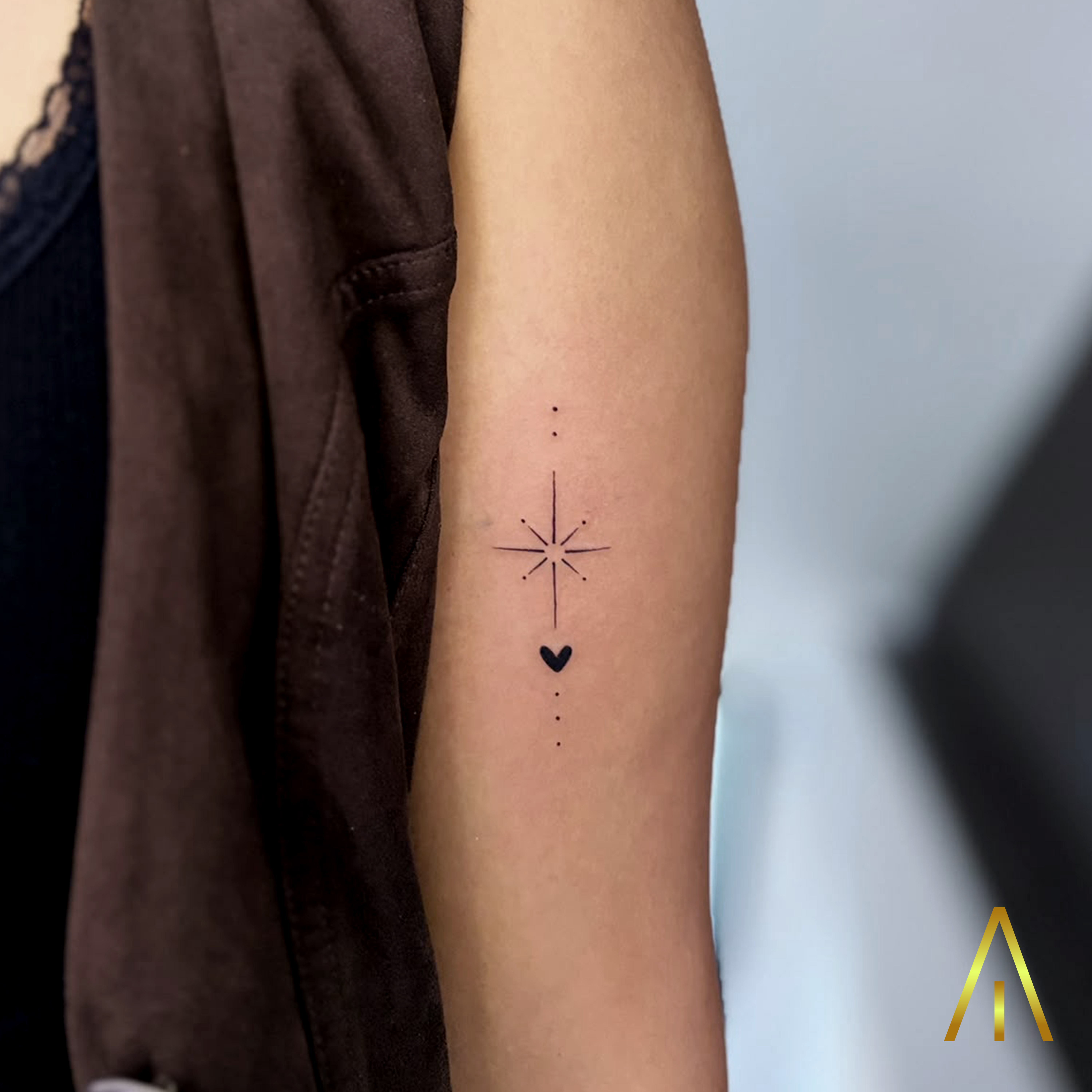 Katie fine line starburst and heart upper arm tattoo Chiang Mai