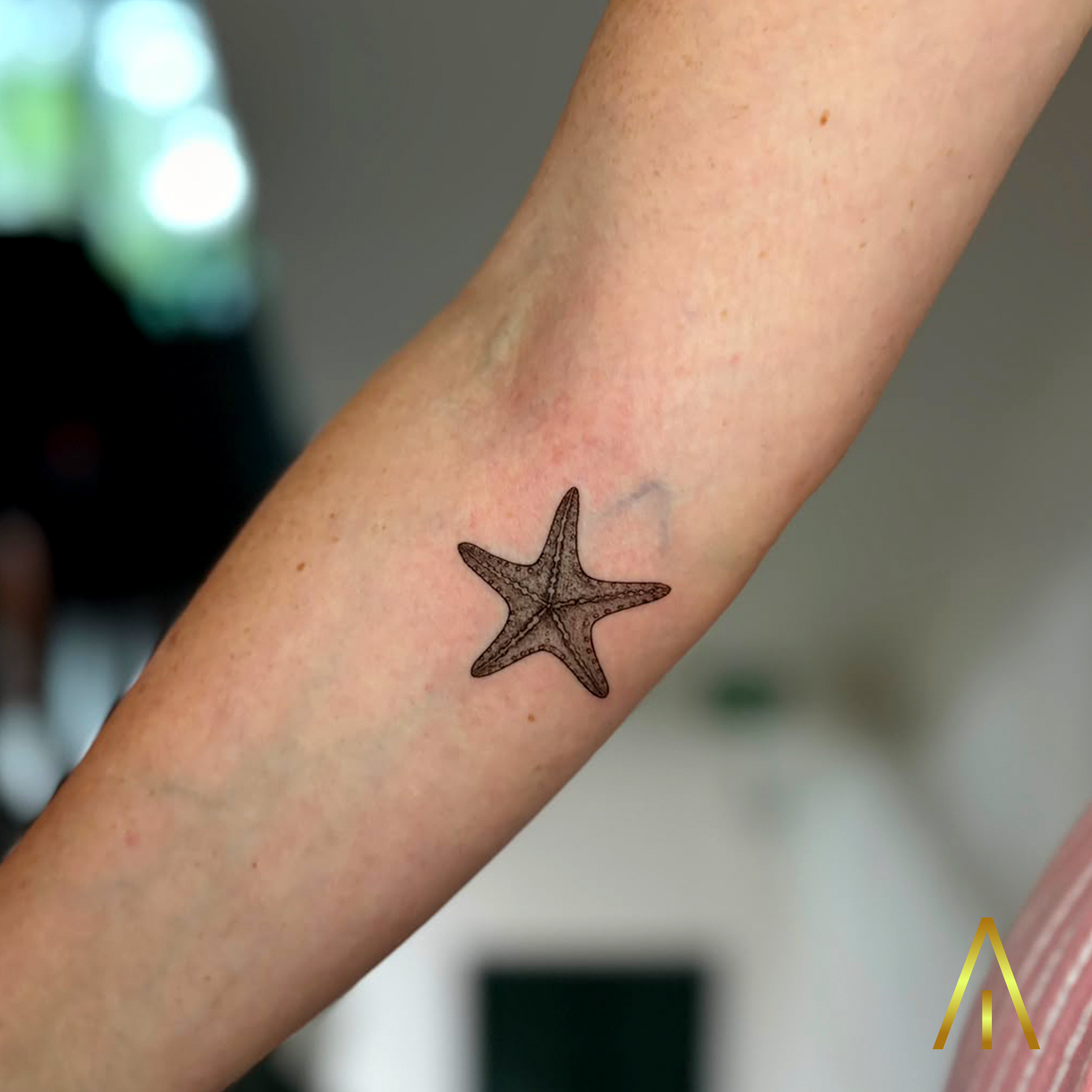Minimal starfish fine line forearm tattoo Chiang Mai