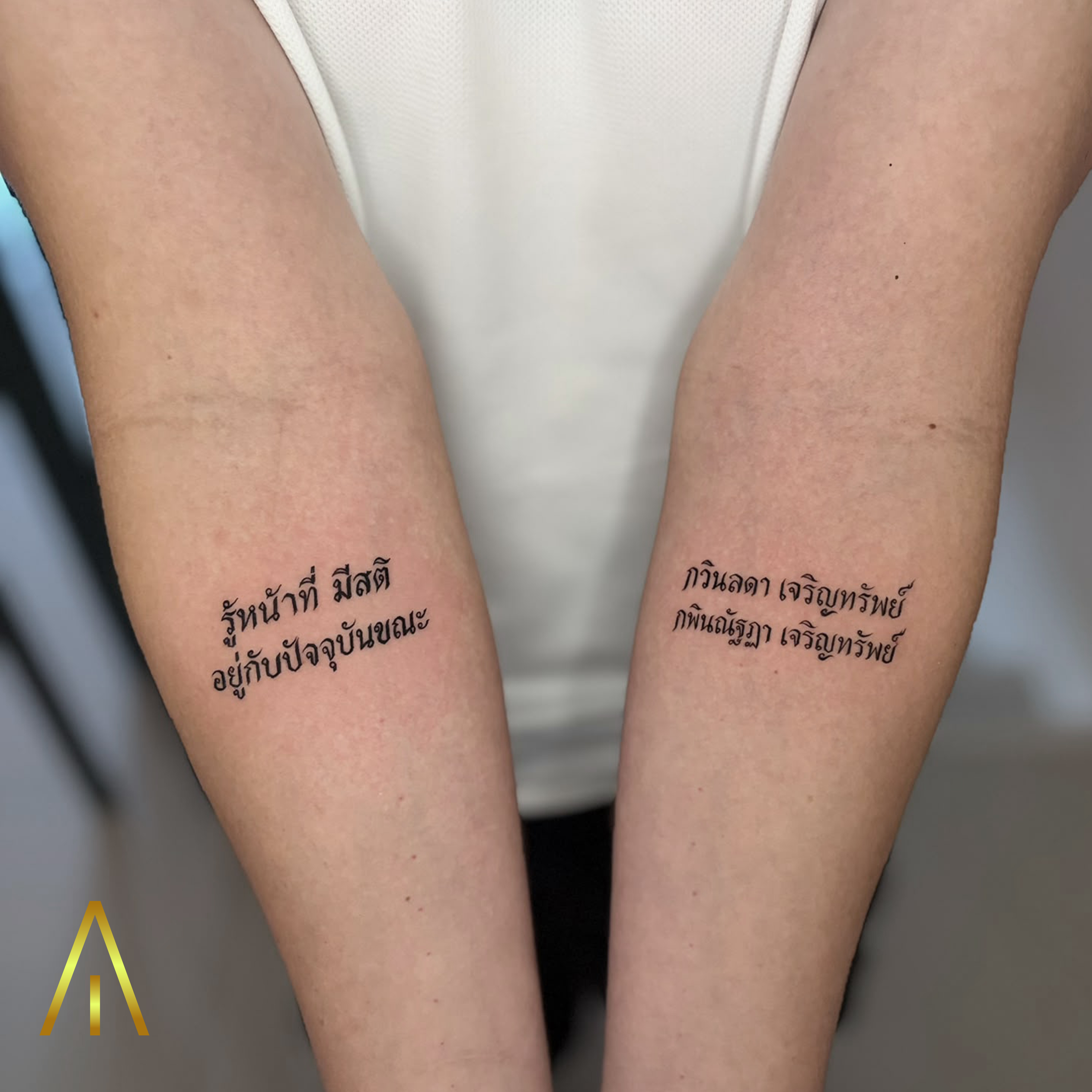 Mimi matching Thai script fine line inner forearm tattoos Chiang Mai