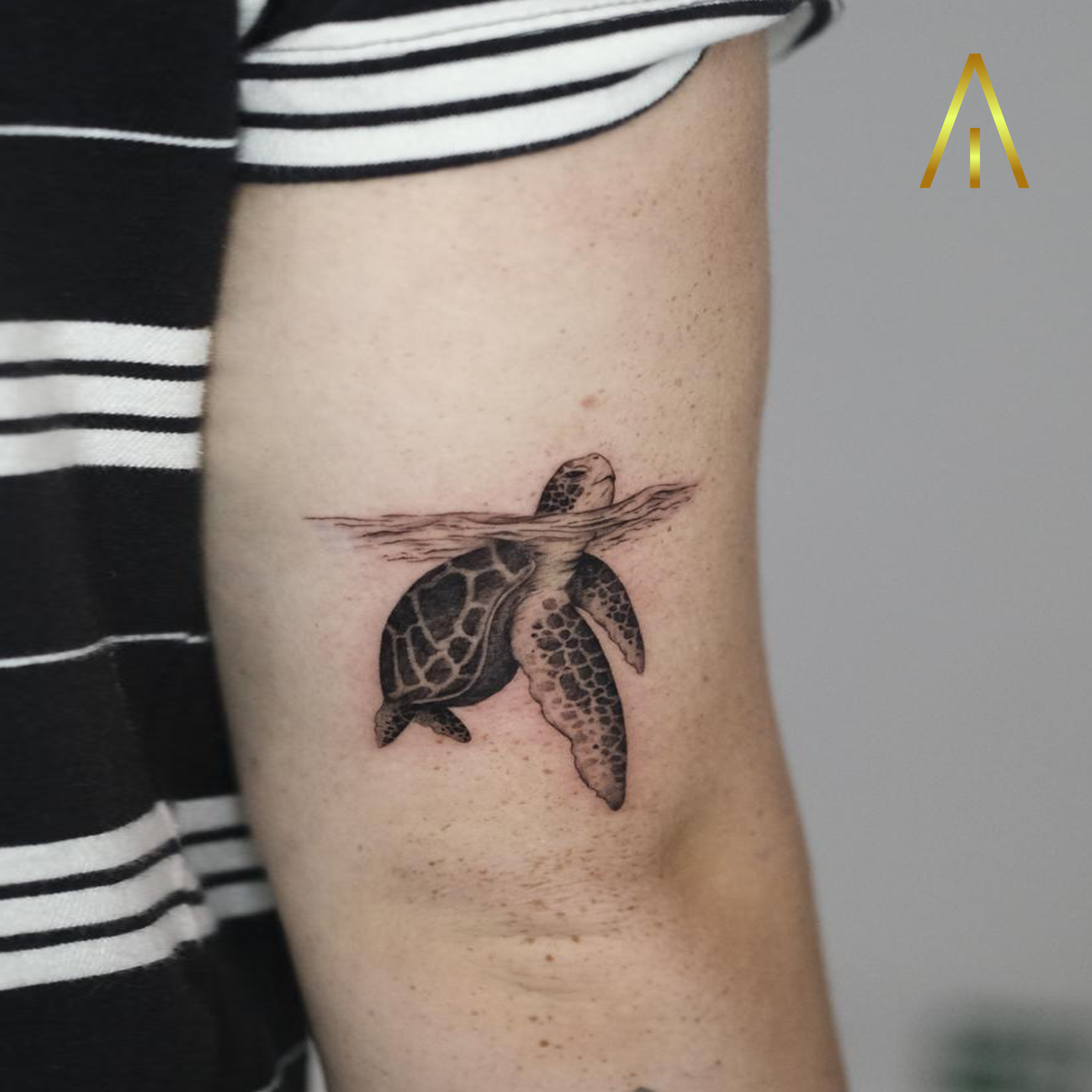 Minimal sea turtle under water upper arm tattoo Chiang Mai