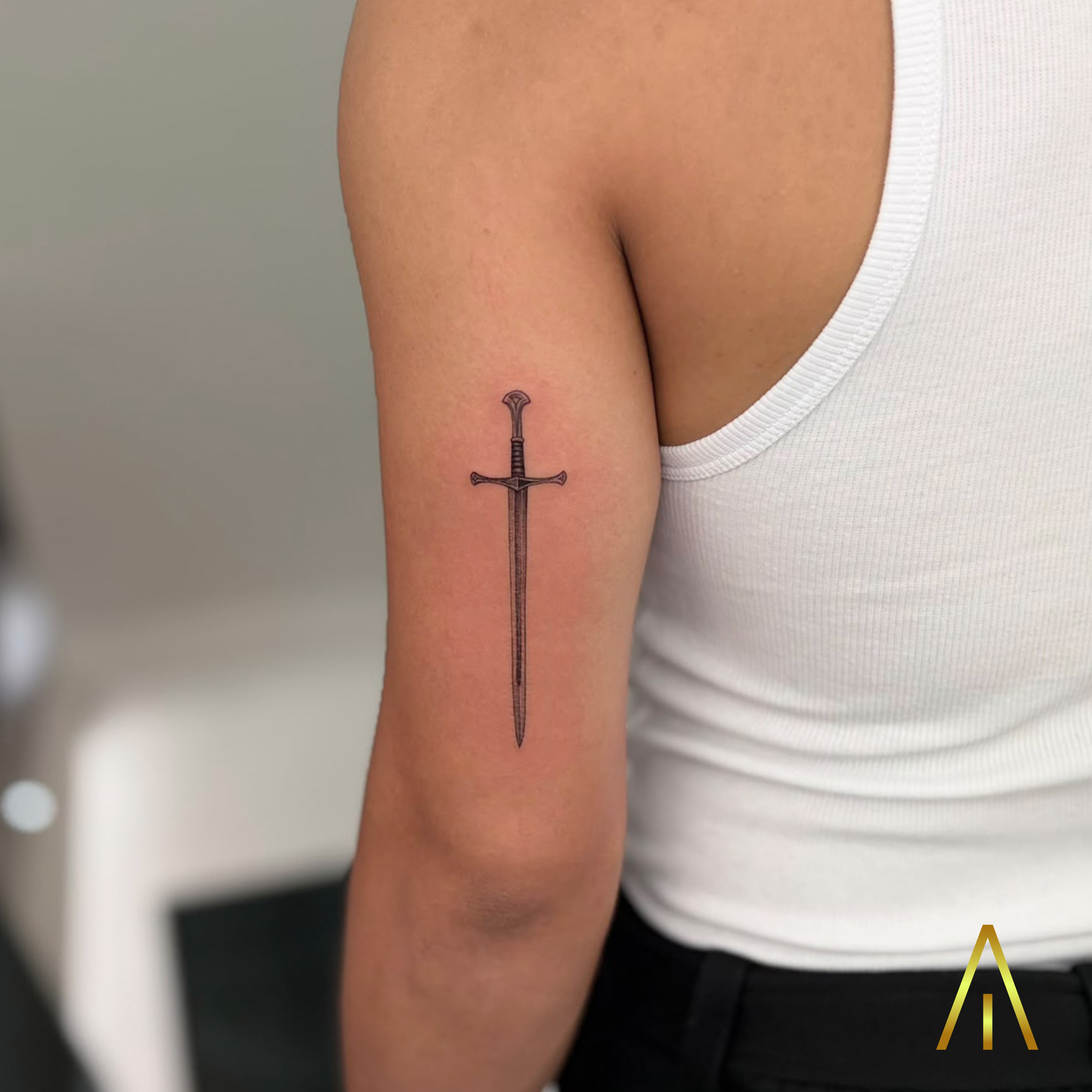 Minimal fine line sword upper arm tattoo Chiang Mai