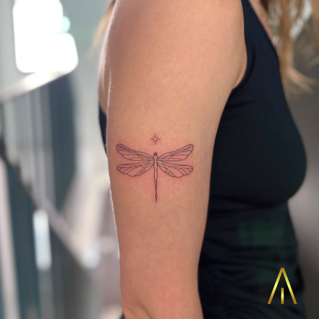 Fine line dragonfly upper arm tattoo Chiang Mai