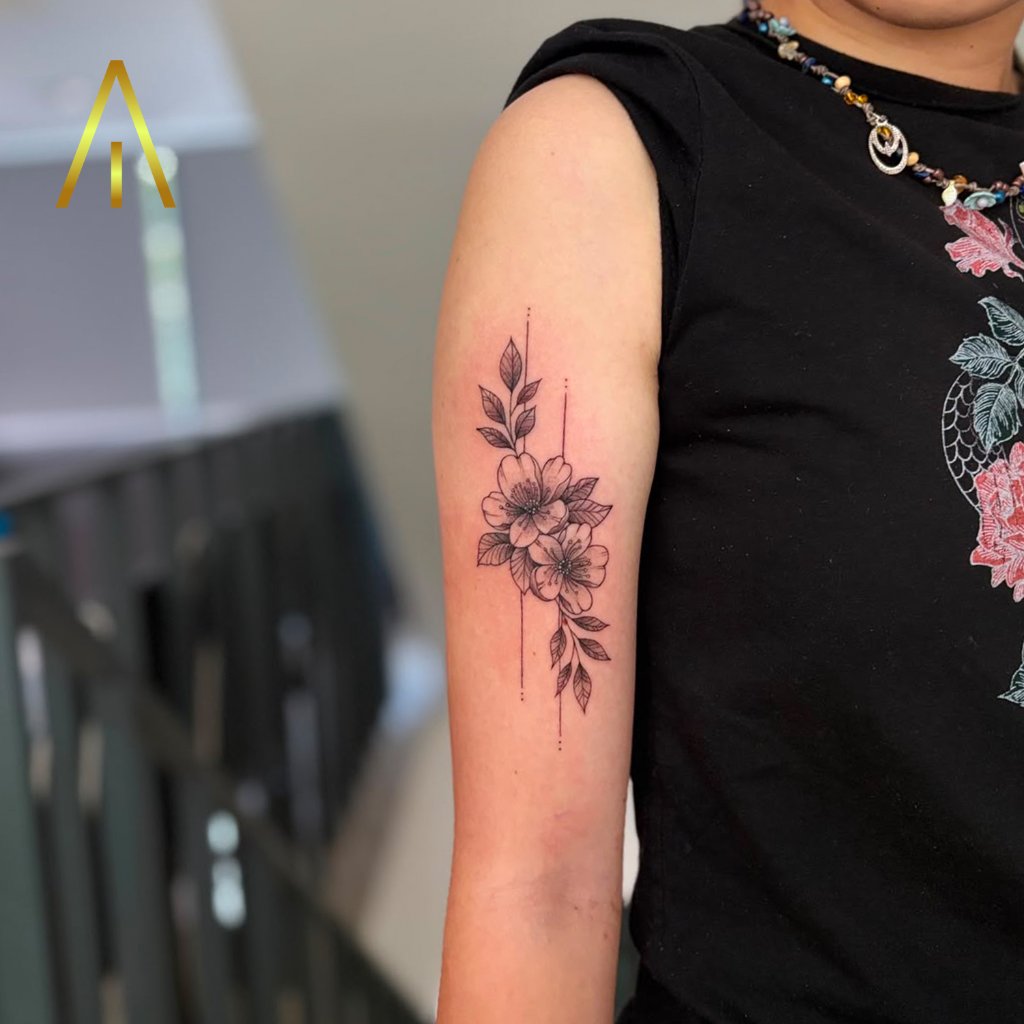Minimal cherry blossoms tattoo on upper arm Chiang Mai