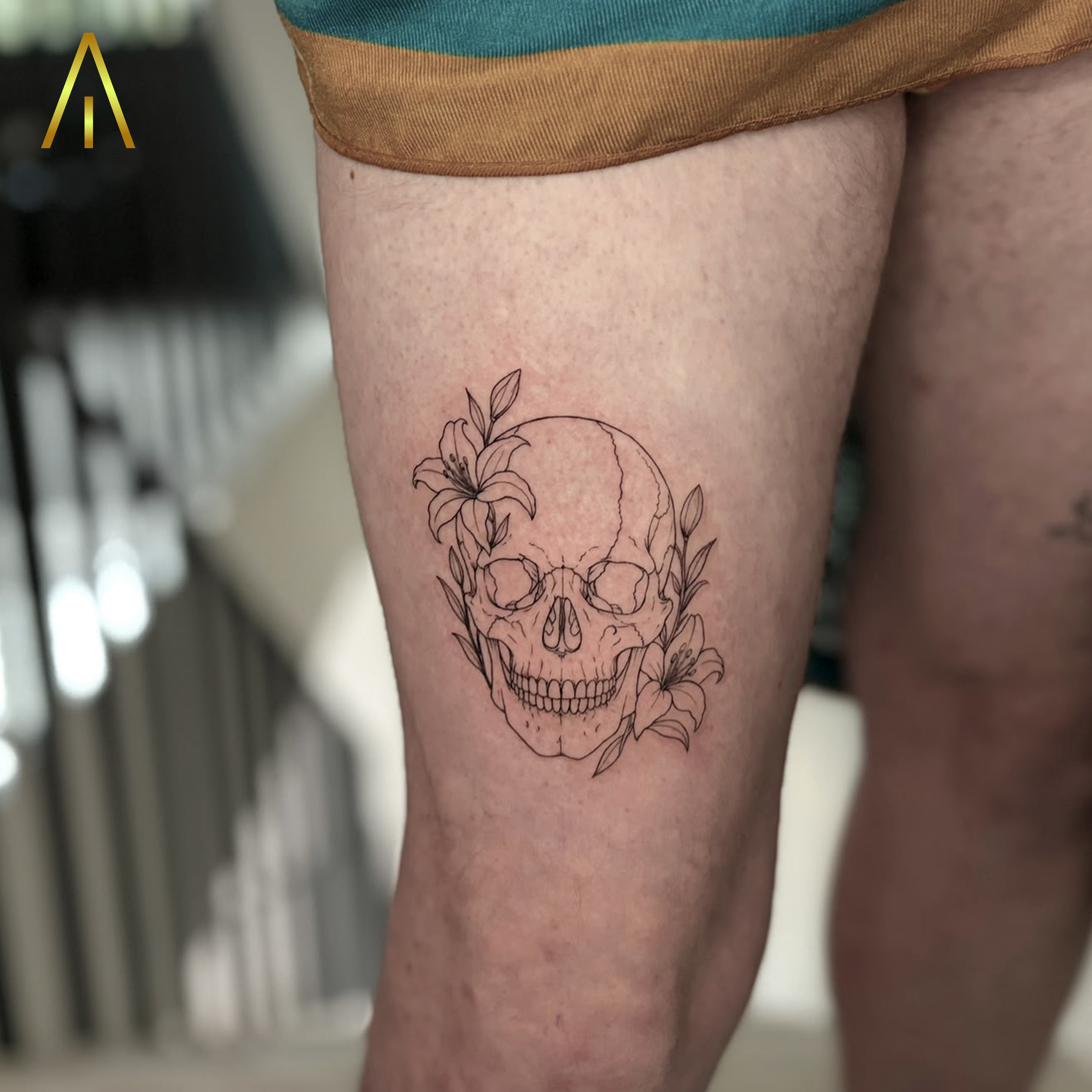 Mimi fine line skull and lilies thigh tattoo Chiang Mai