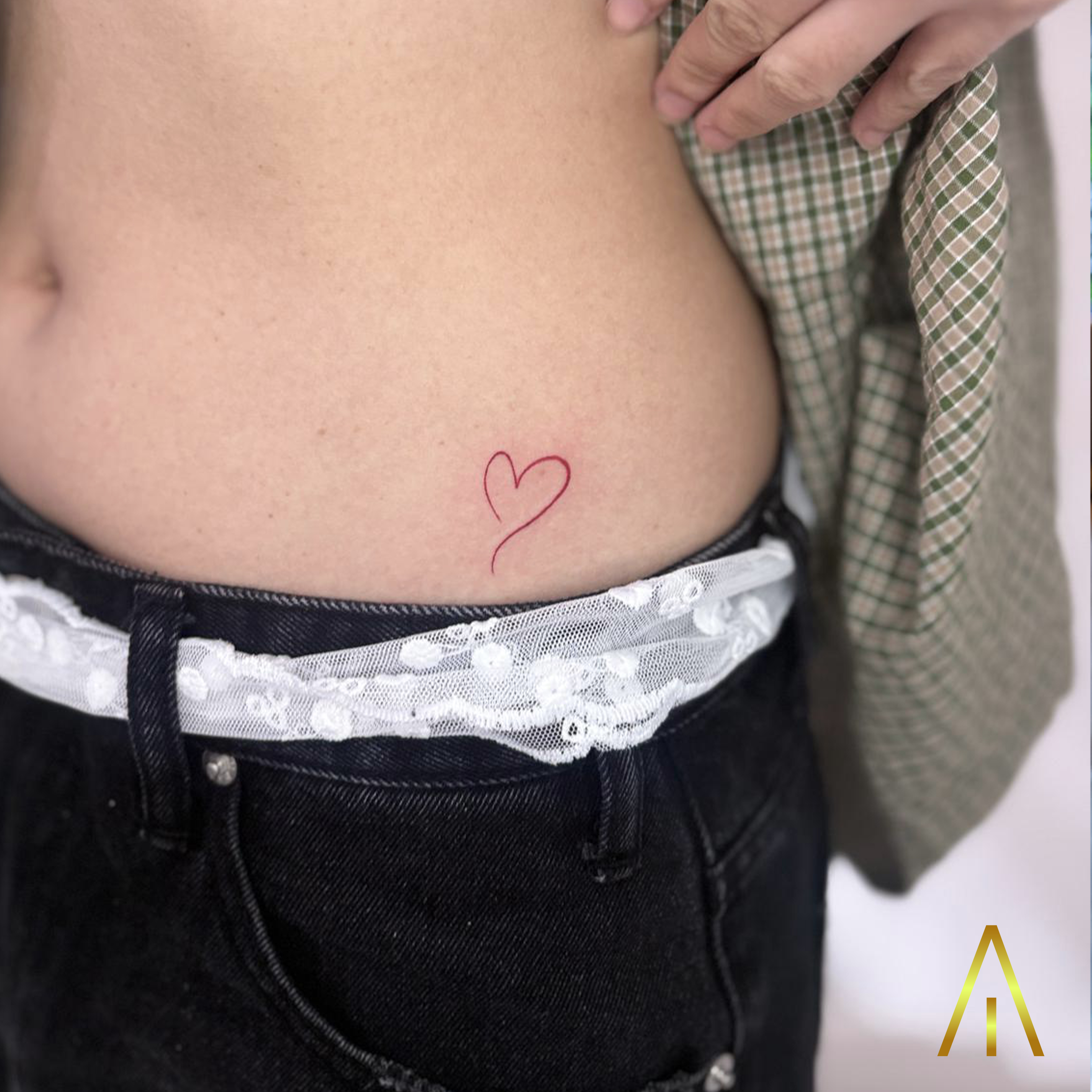 Fine line red ink heart hip tattoo Chiang Mai