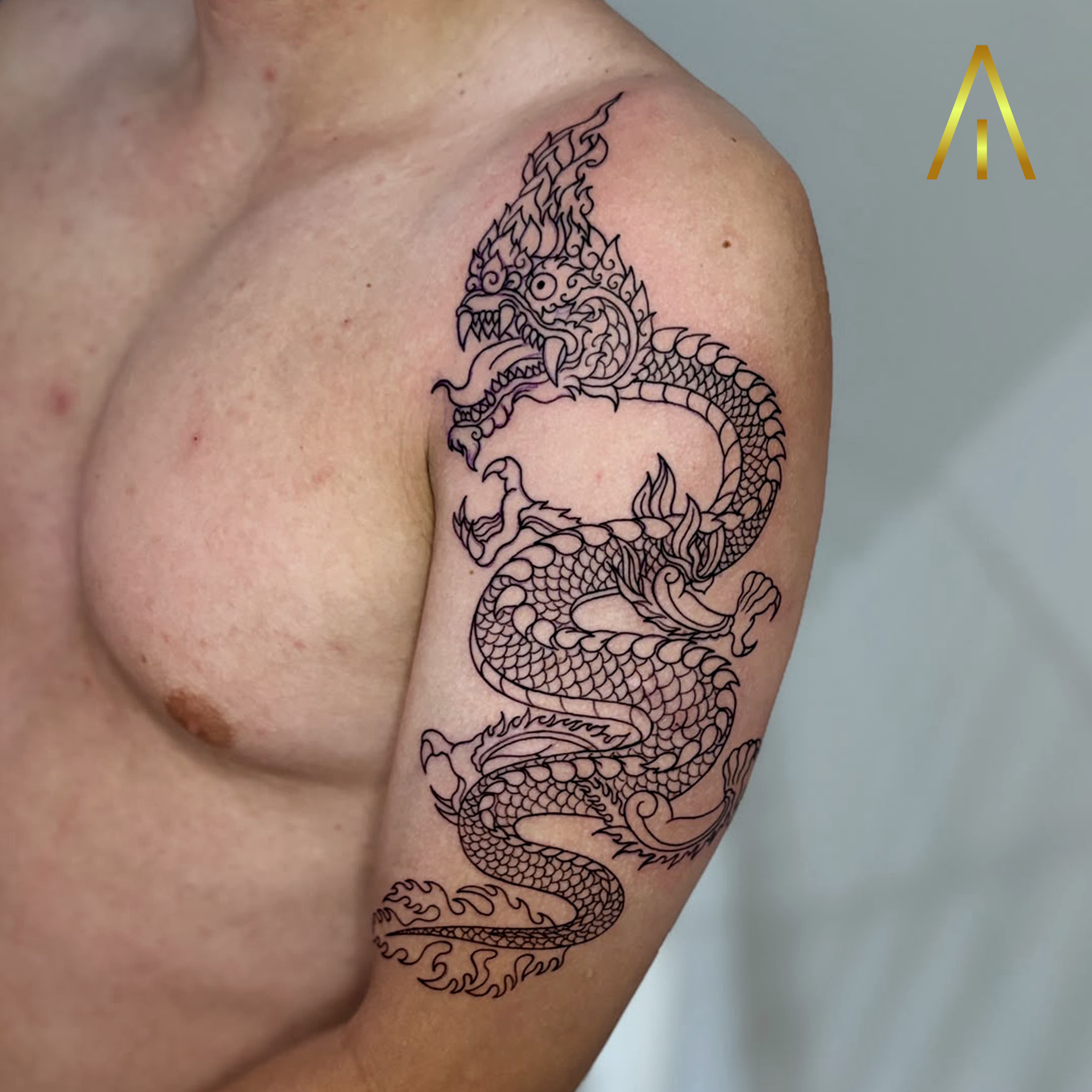 Taely blackwork dragon upper arm shoulder tattoo Chiang Mai