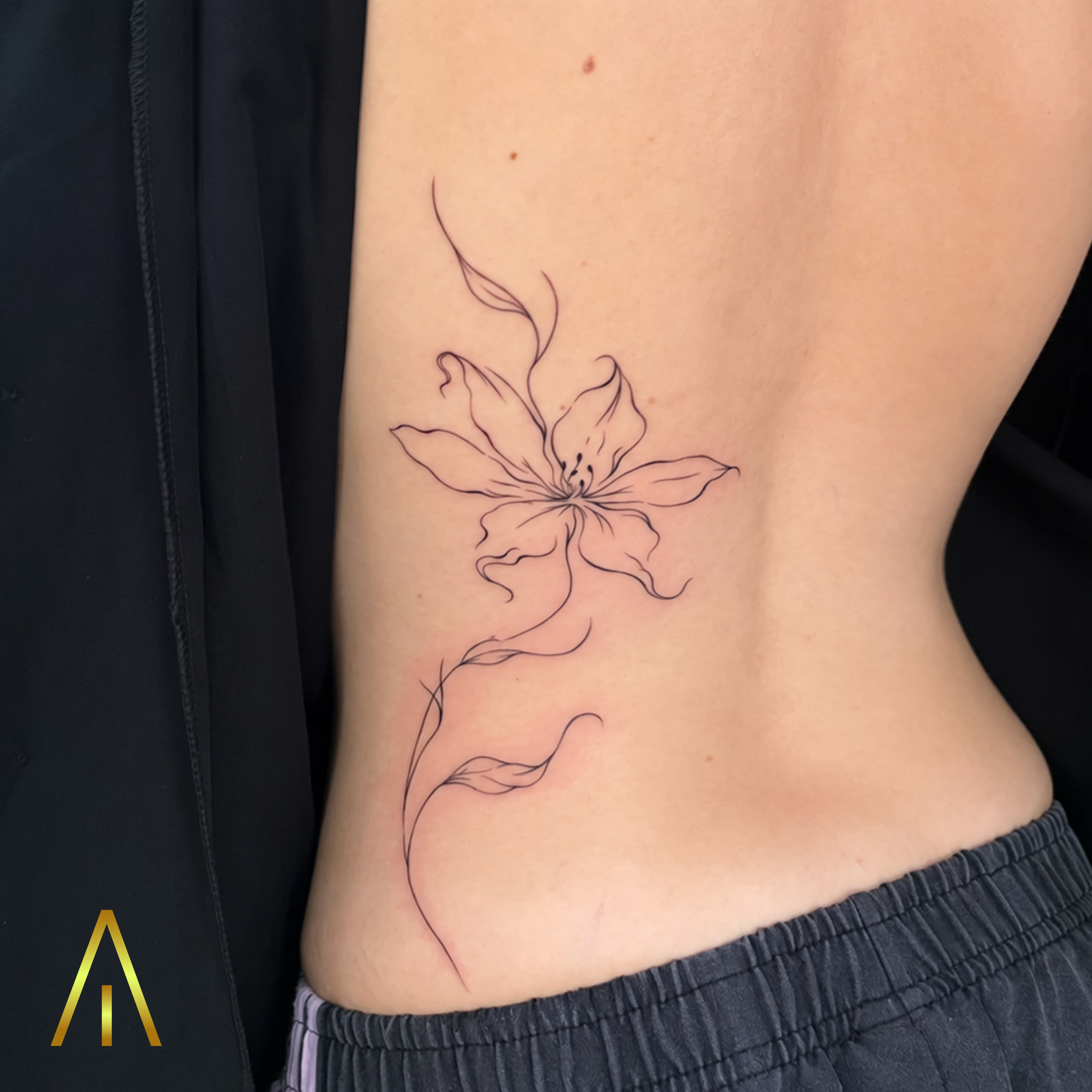 Miaa lily flower fine line ribcage tattoo Chiang Mai