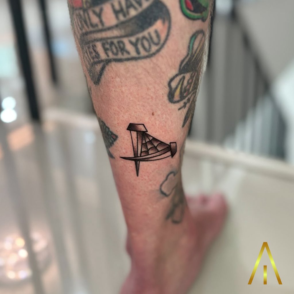 Minimal nail and pizza spiderweb tattoo on leg Chiang Mai