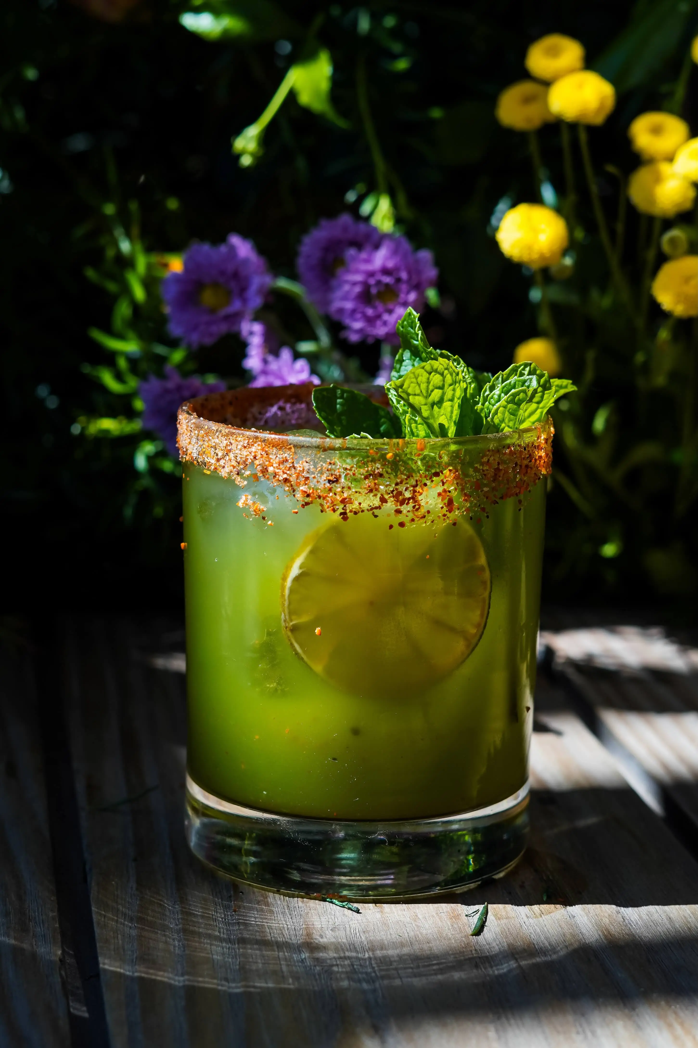 Vibrant green cocktail with spiced rim