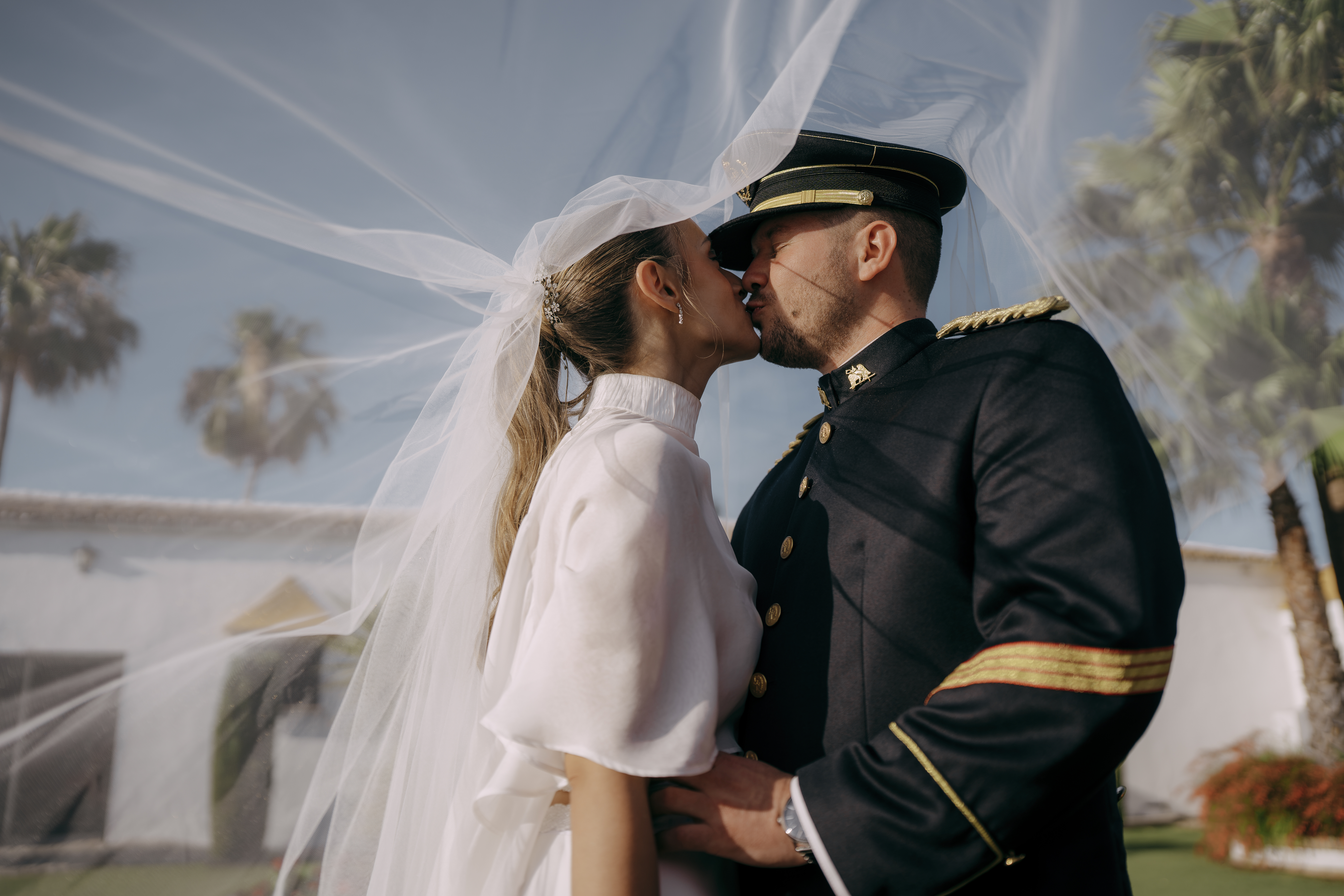 Beso de los novios tras el velo durante la boda