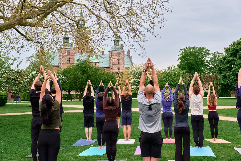 Yoga class in Kongens Have with Rosenborg Castle in the background