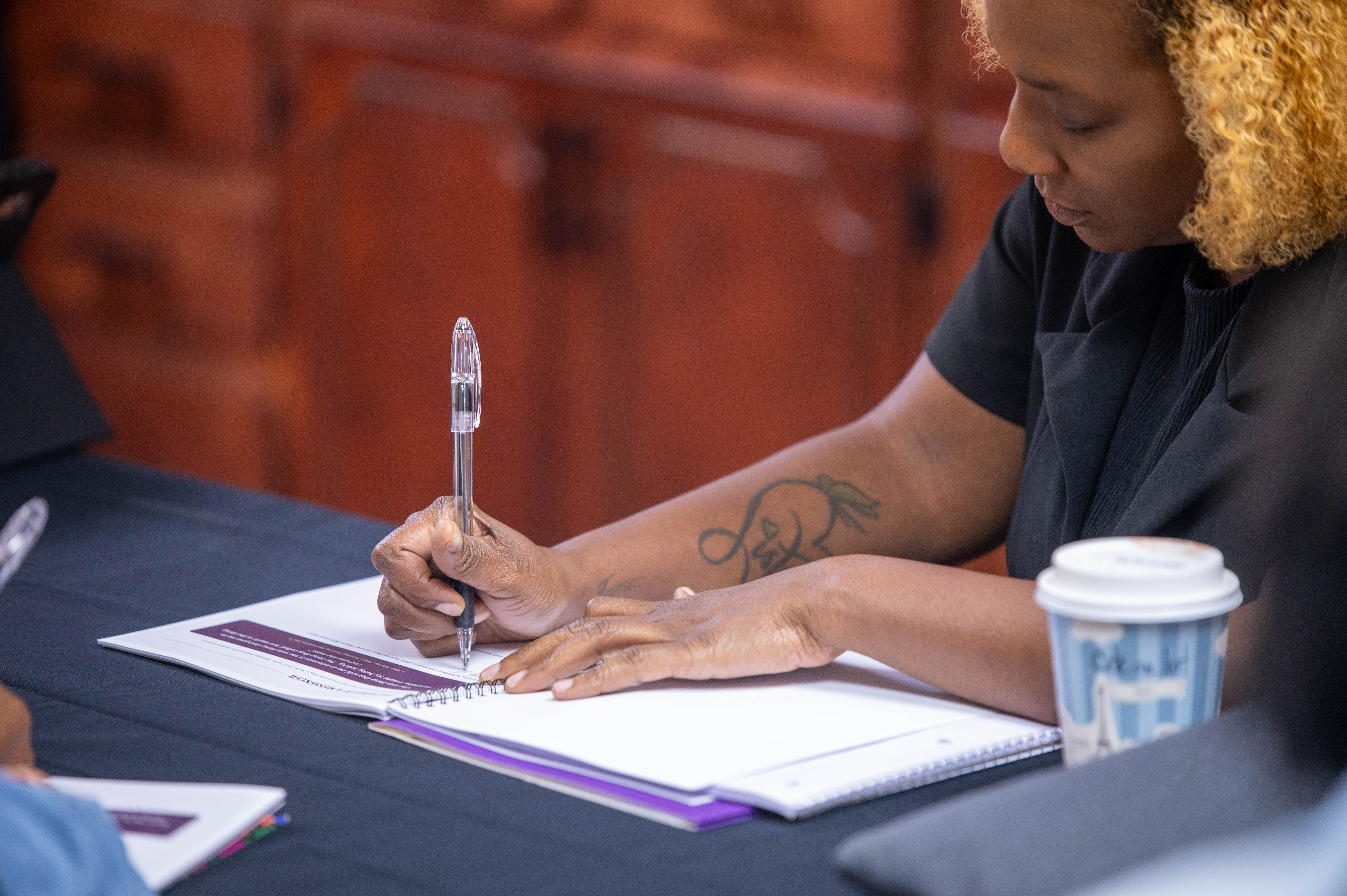 A participant writing in the CPS Masterclass workbook