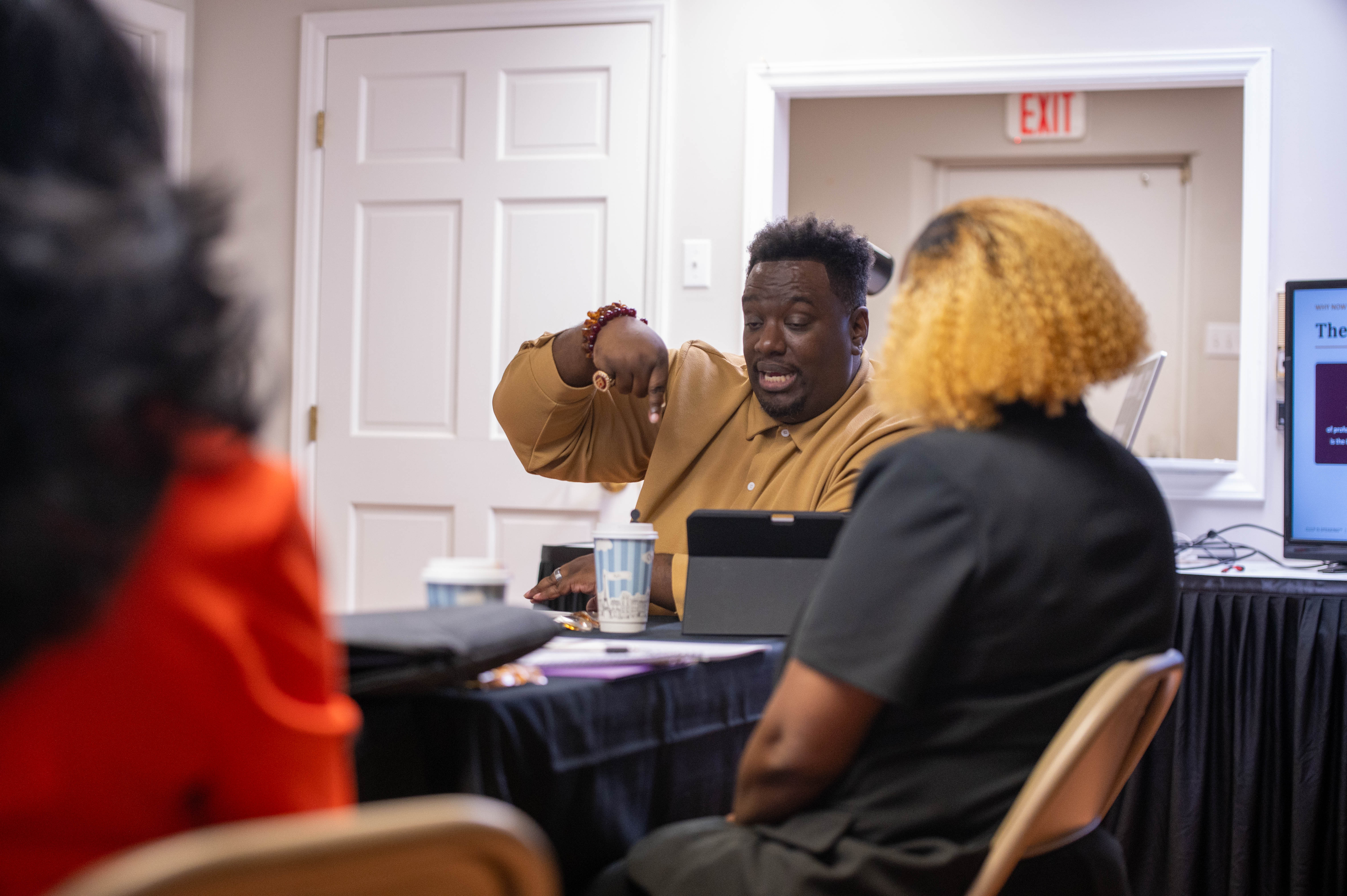 Terrance L. Culp leaning in to coach a participant one-on-one during the CPS Masterclass