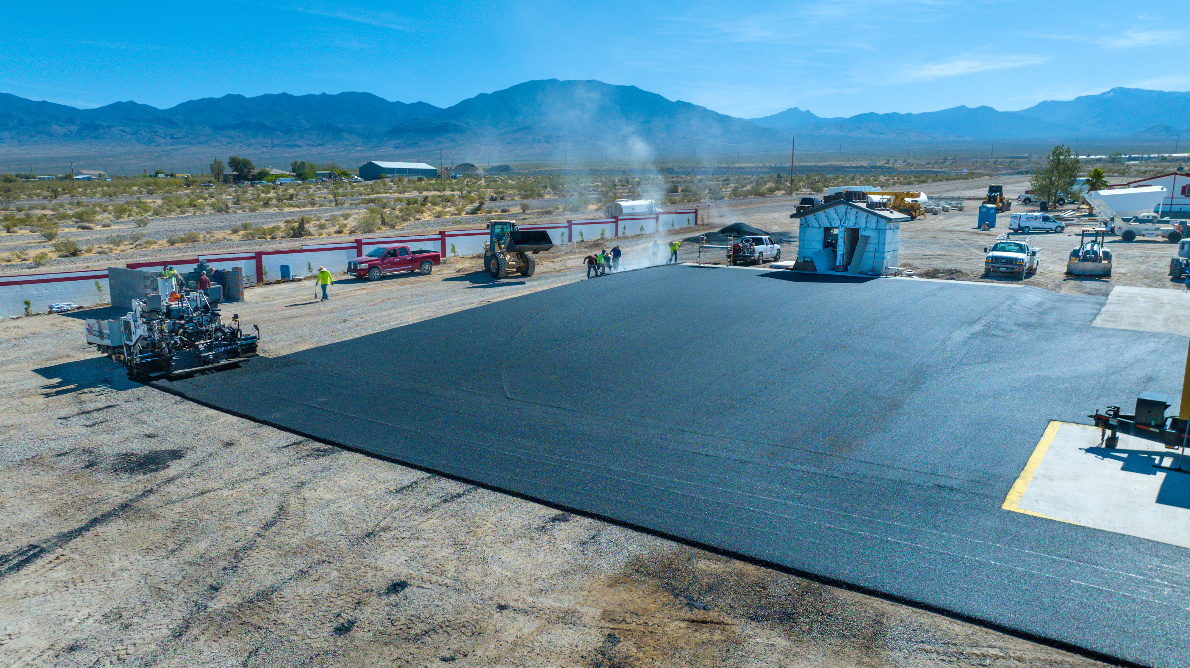 Paver and crew on fresh asphalt