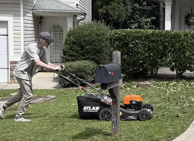 Cameron Manly mowing a lawn for a Canton GA lawn care customer