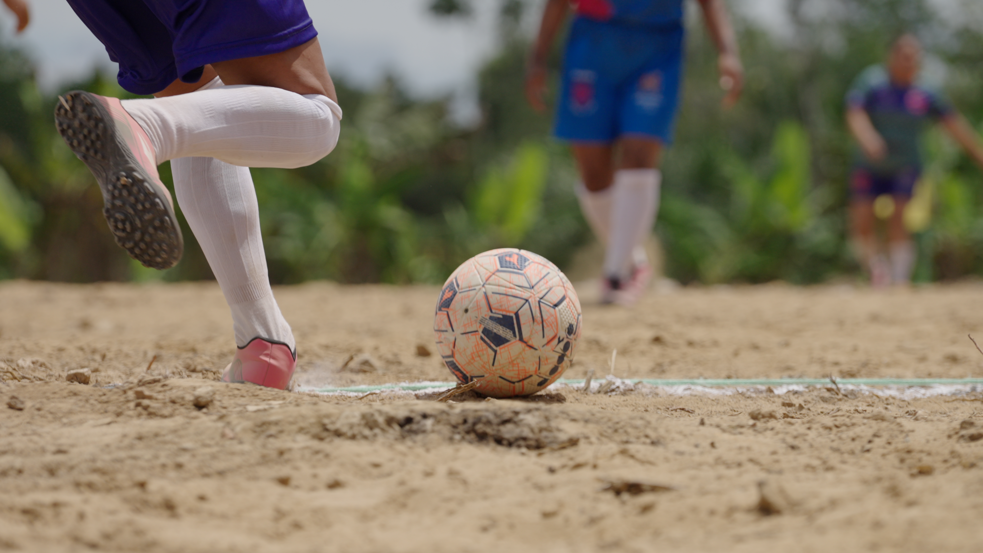 Low-angle action shot of a player striking the ball