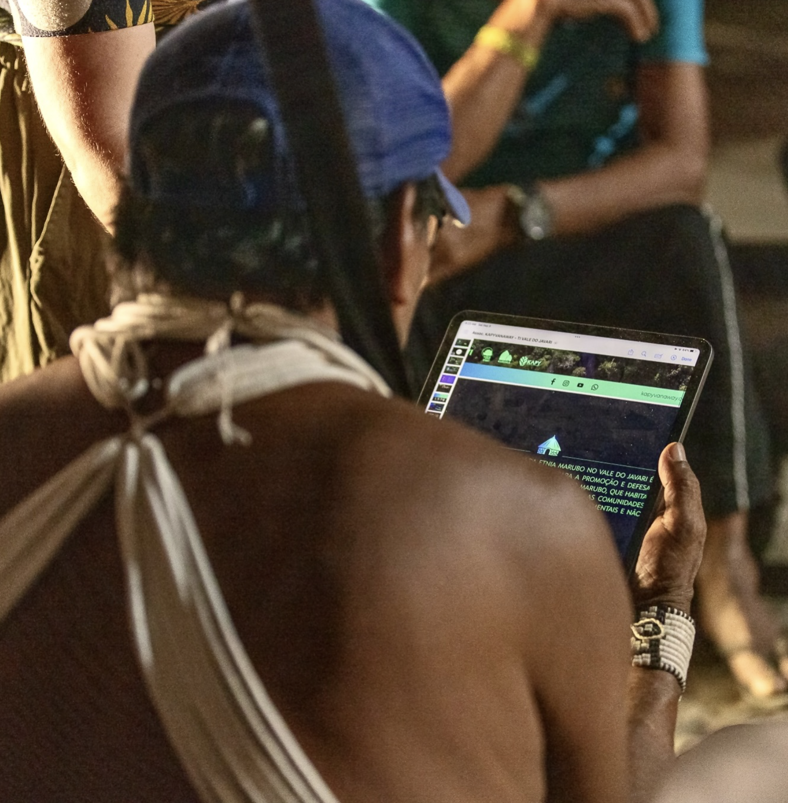 Indigenous person browsing the Kapyvanaway Association website on a tablet