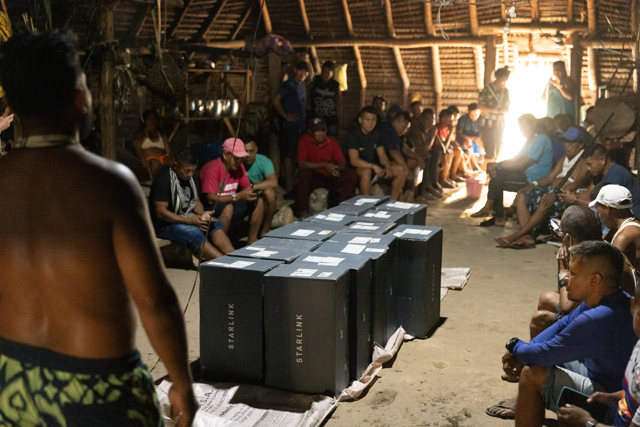 The boxes wait while the community decides, together, how to use what has arrived.