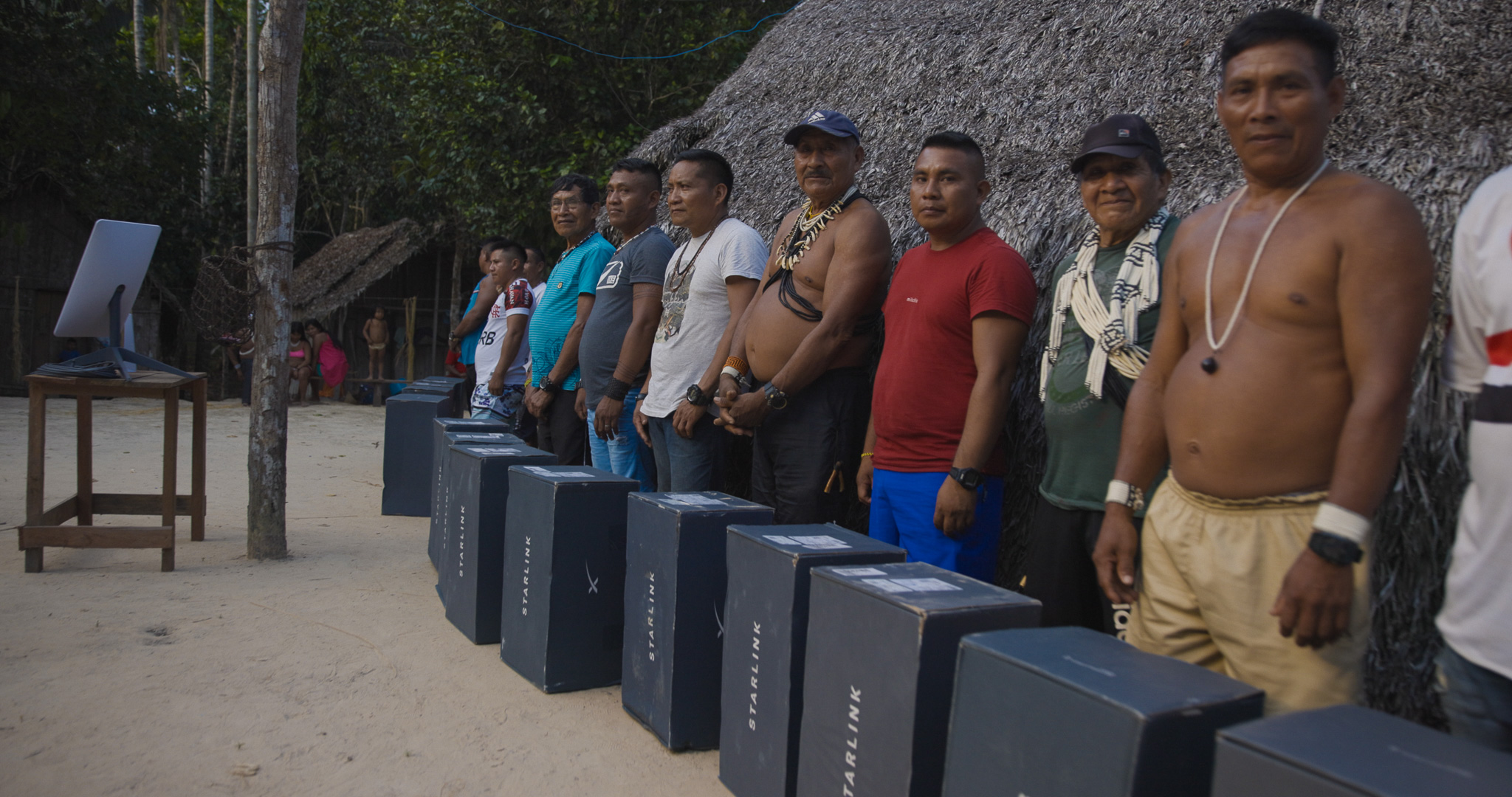 Starlink boxes lined up before the maloca — the equipment arrives, but the decision belongs to the community.