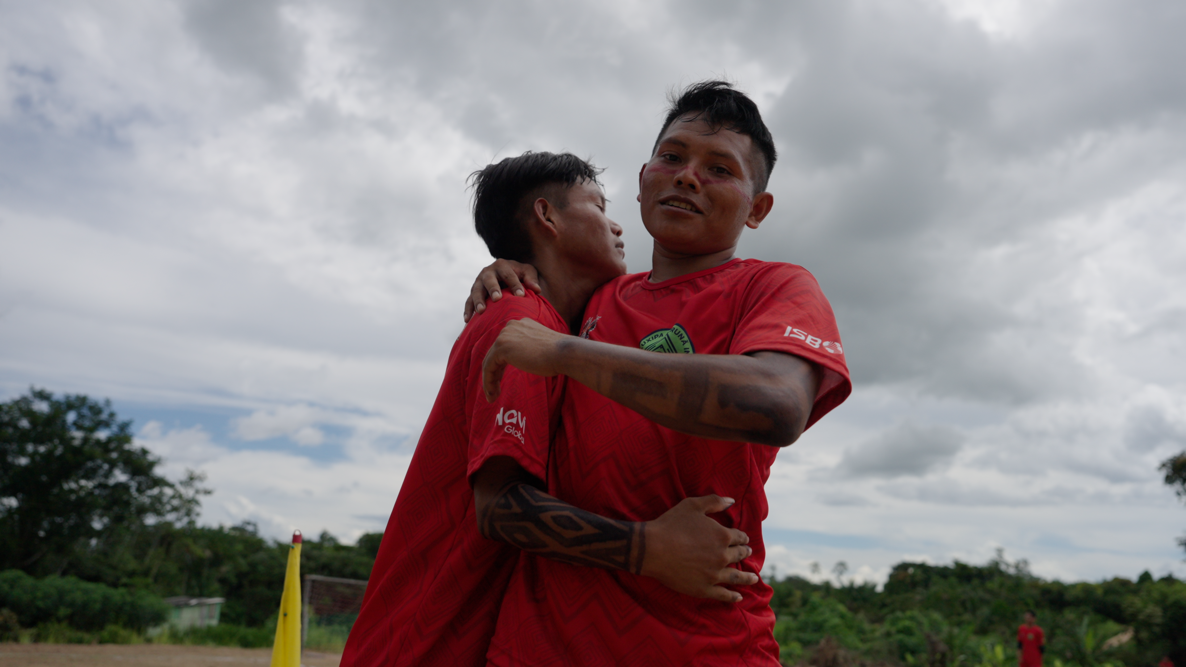Two young Indigenous men embracing in celebration