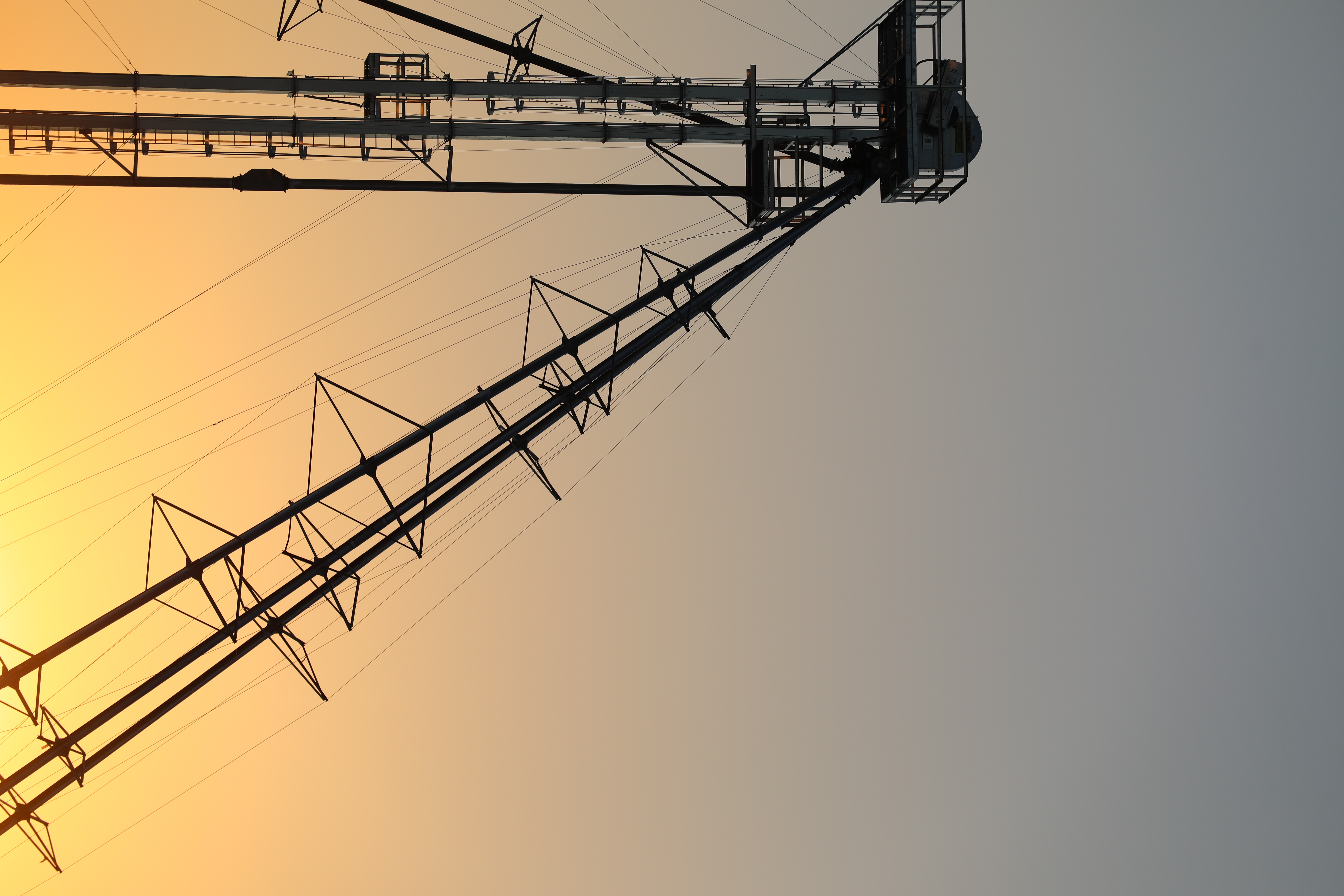 Grain elevator arm silhouetted at golden hour