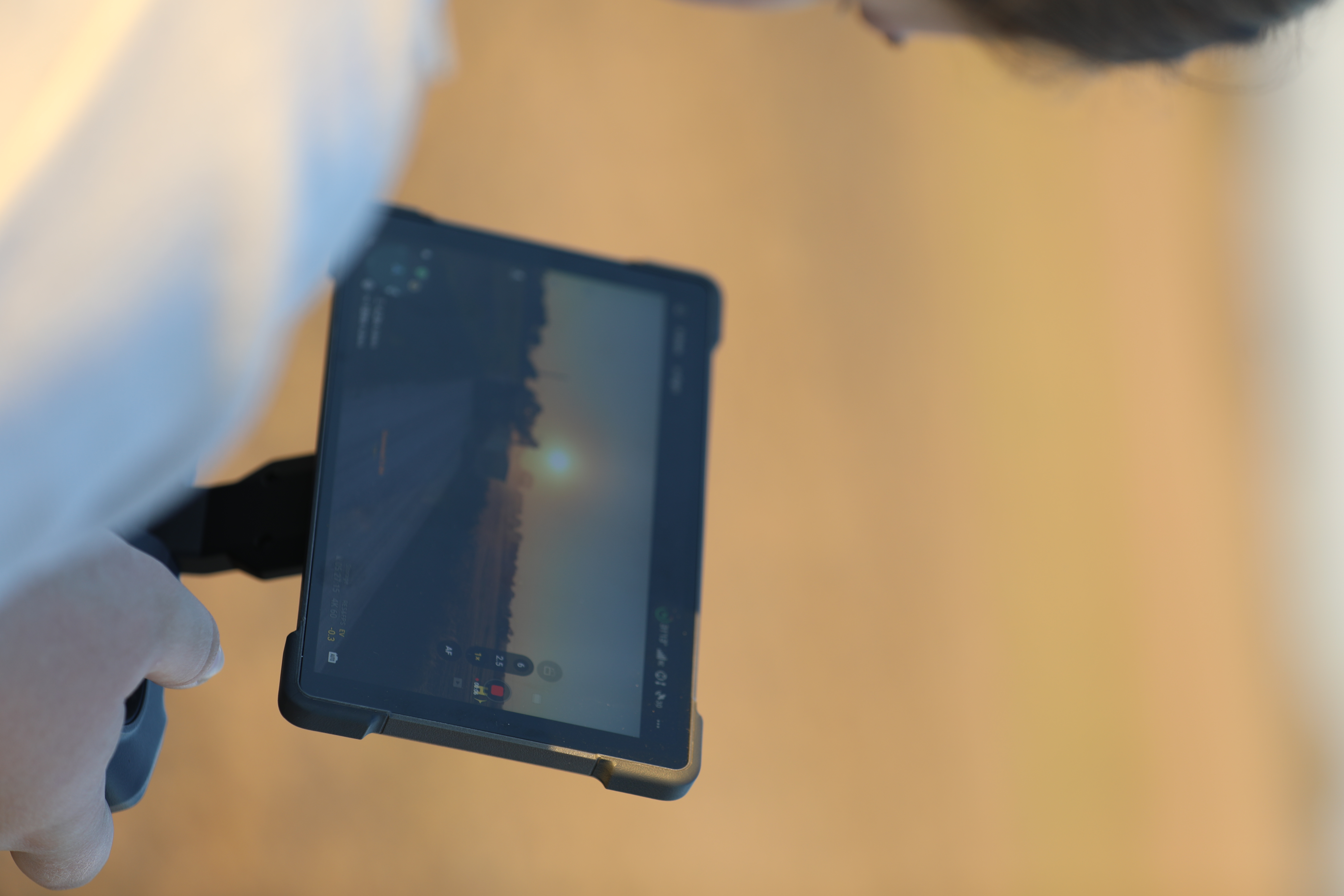 Filming a truck silhouette on a stabilizer monitor at sunset