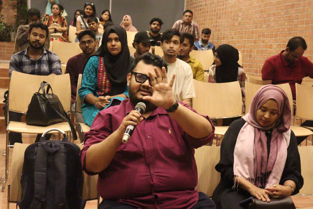 A guest raises a question during Q&A