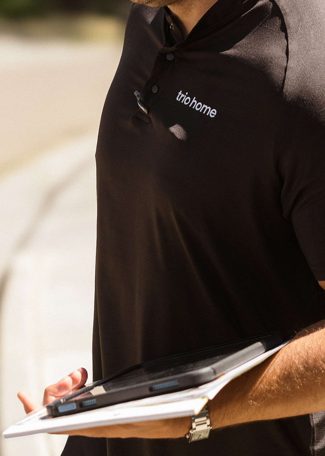 Rep in Trio uniform holding a tablet