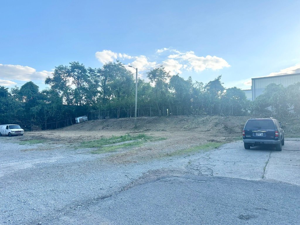 Cleared steep hillside after Back 40 Land Services forestry mulcher removed brush and small trees on Nashville commercial lot — Davidson County TN