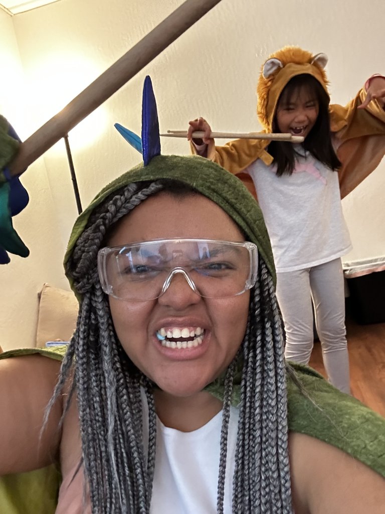 Music therapist and children playing together in fun costumes during a session
