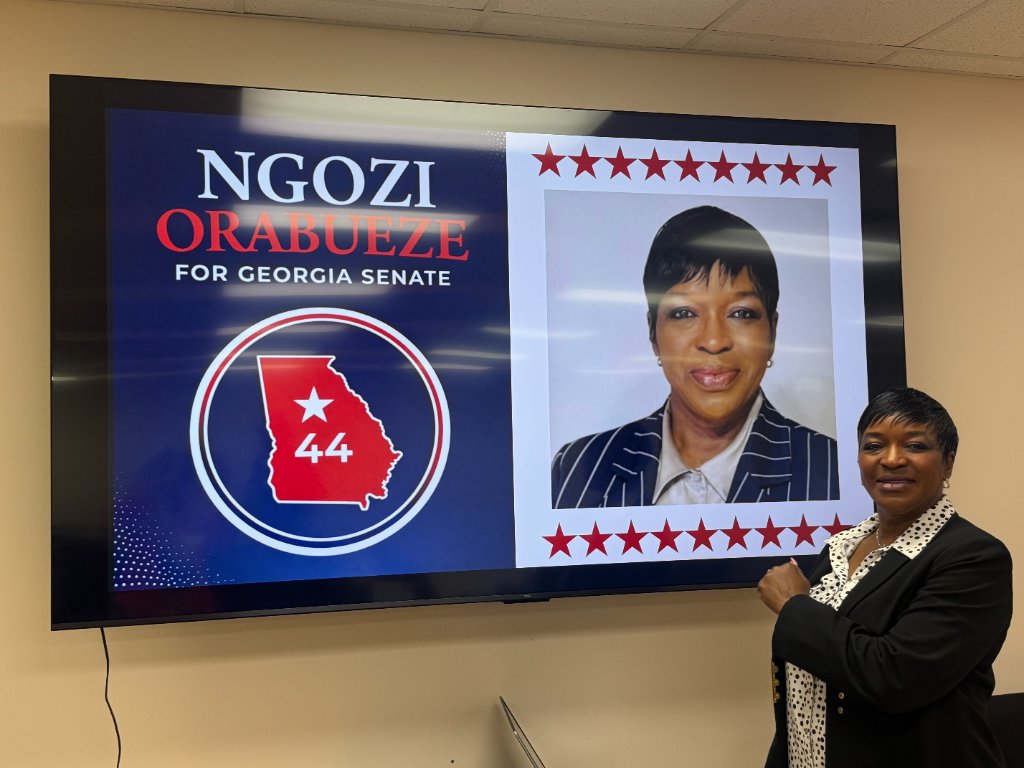 Dr. Orabueze beside her campaign display