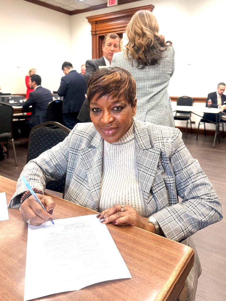 Dr. Orabueze working at a conference table