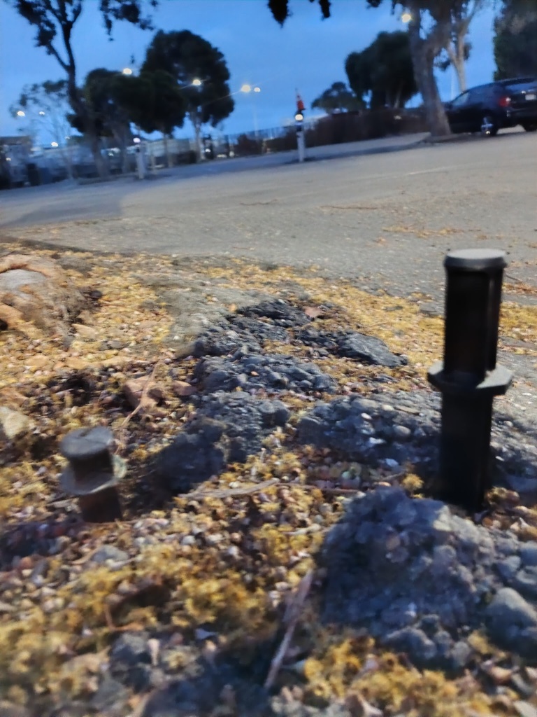 Broken generic stakes snapped off at ground level — lights missing