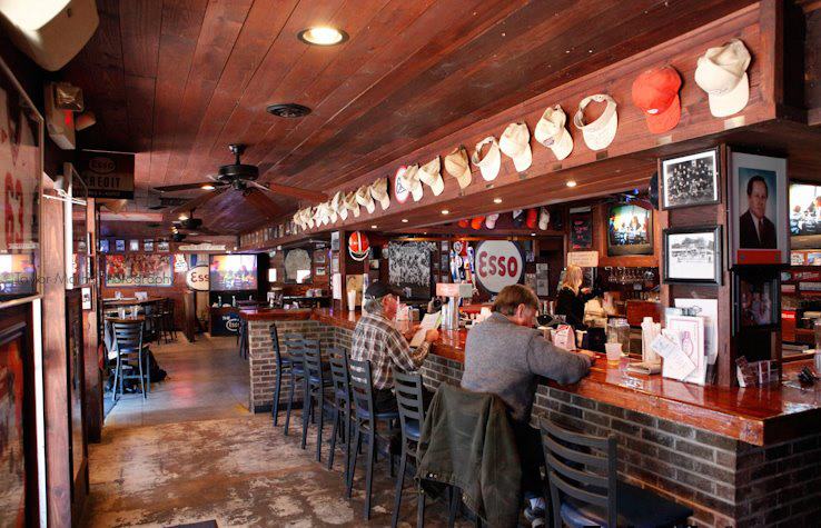 Classic Clemson bar at dusk with fans outside