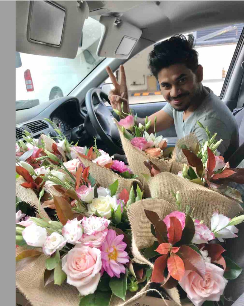 Little Flowers delivery driver preparing locally grown rose bundles for same-day eco-friendly van batch delivery