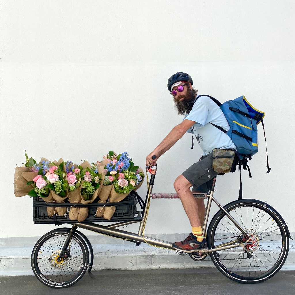 Zero-emissions cargo bike loaded with locally grown Australian rose bunches for Sydney CBD same-day delivery