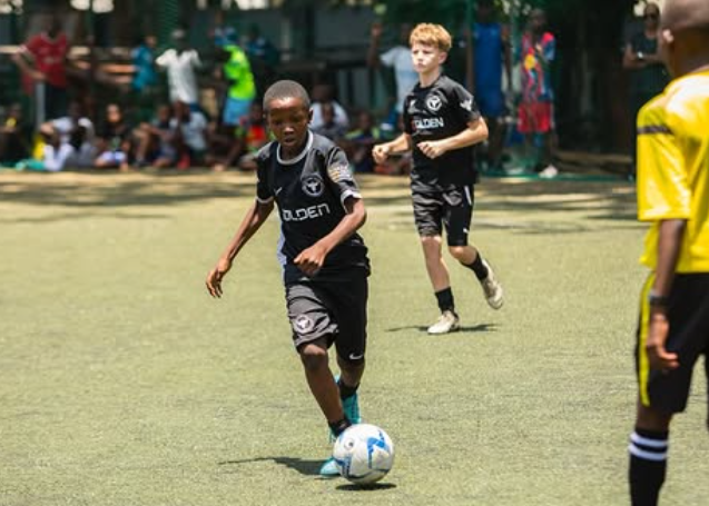 Young athlete dribbling the football